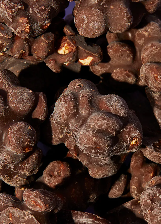 a close up of a pile of chocolate covered nuts