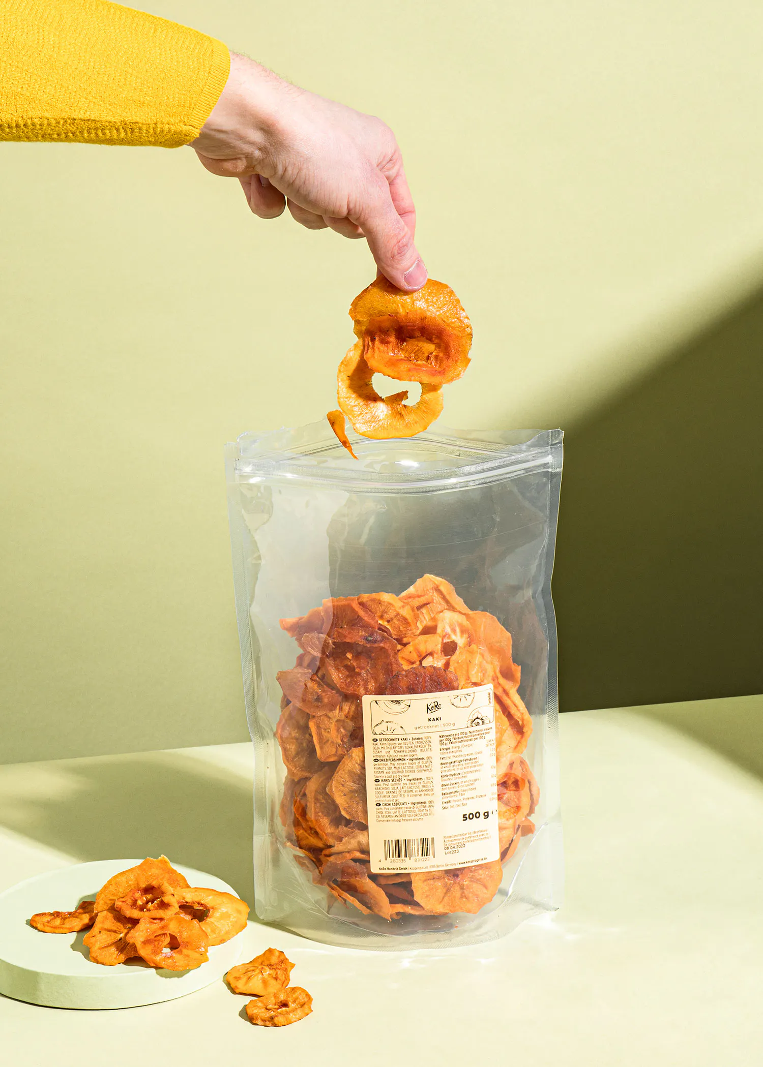 a person is reaching into a bag of chips that says 500g on it