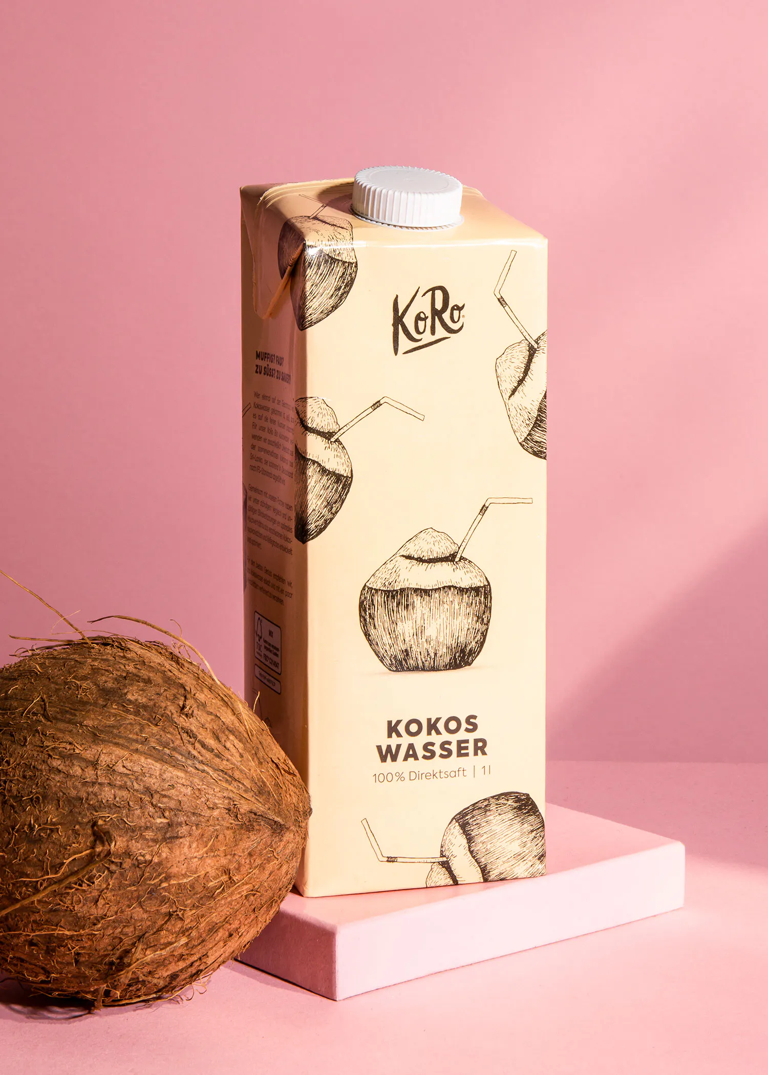 a carton of kokos wasser next to a coconut