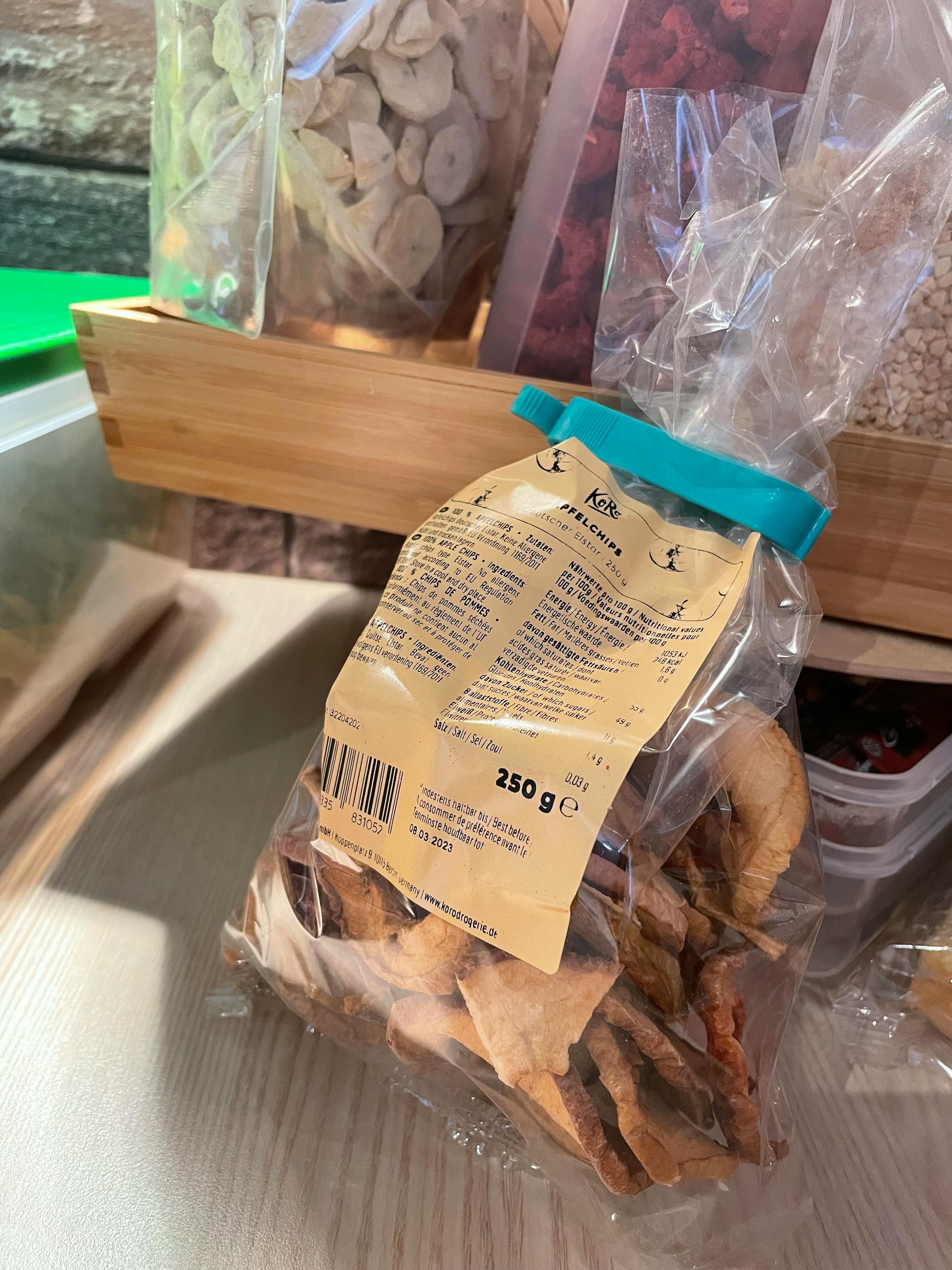 a bag of dried apples sits on a wooden table
