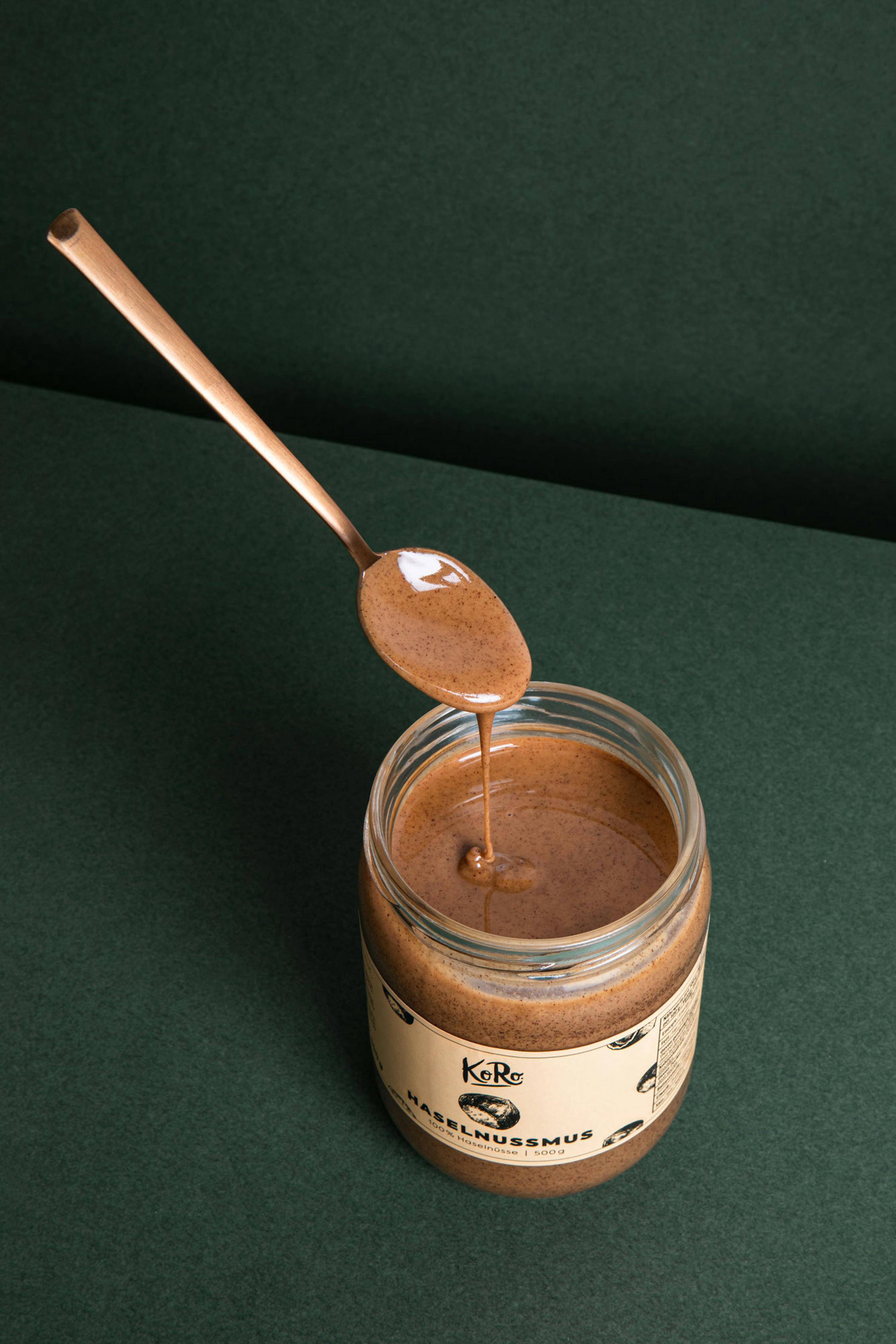 a jar of hazelnussmus with a spoon sticking out of it