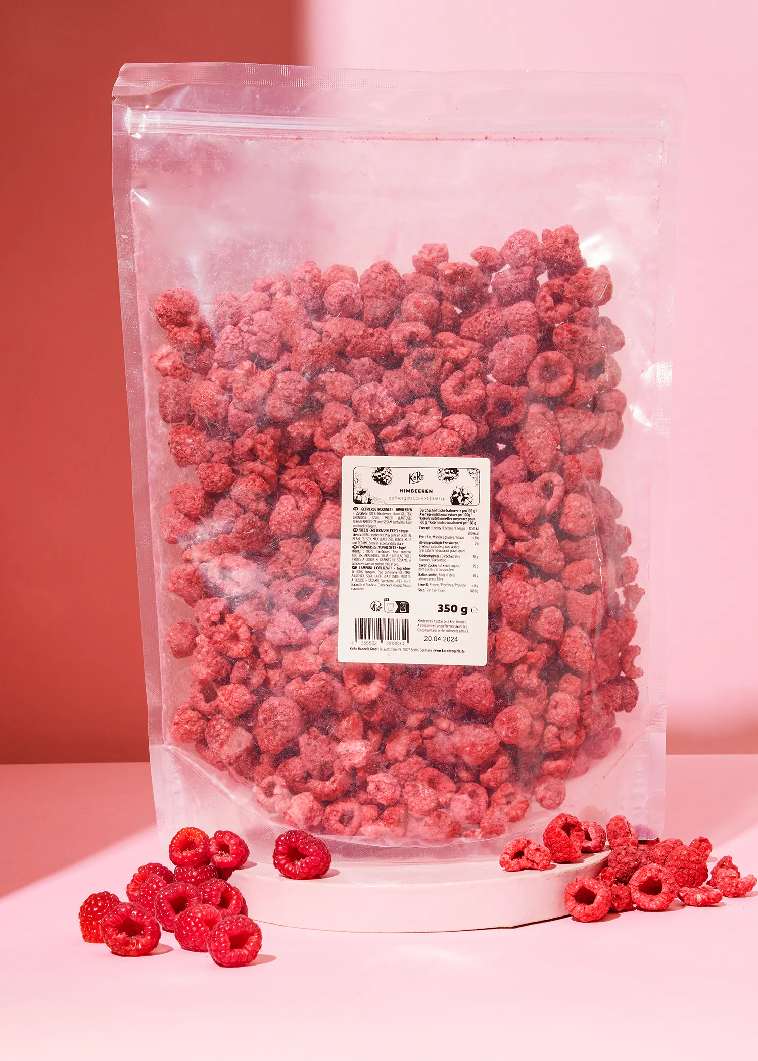 a bag of freeze dried raspberries sits on a pink table