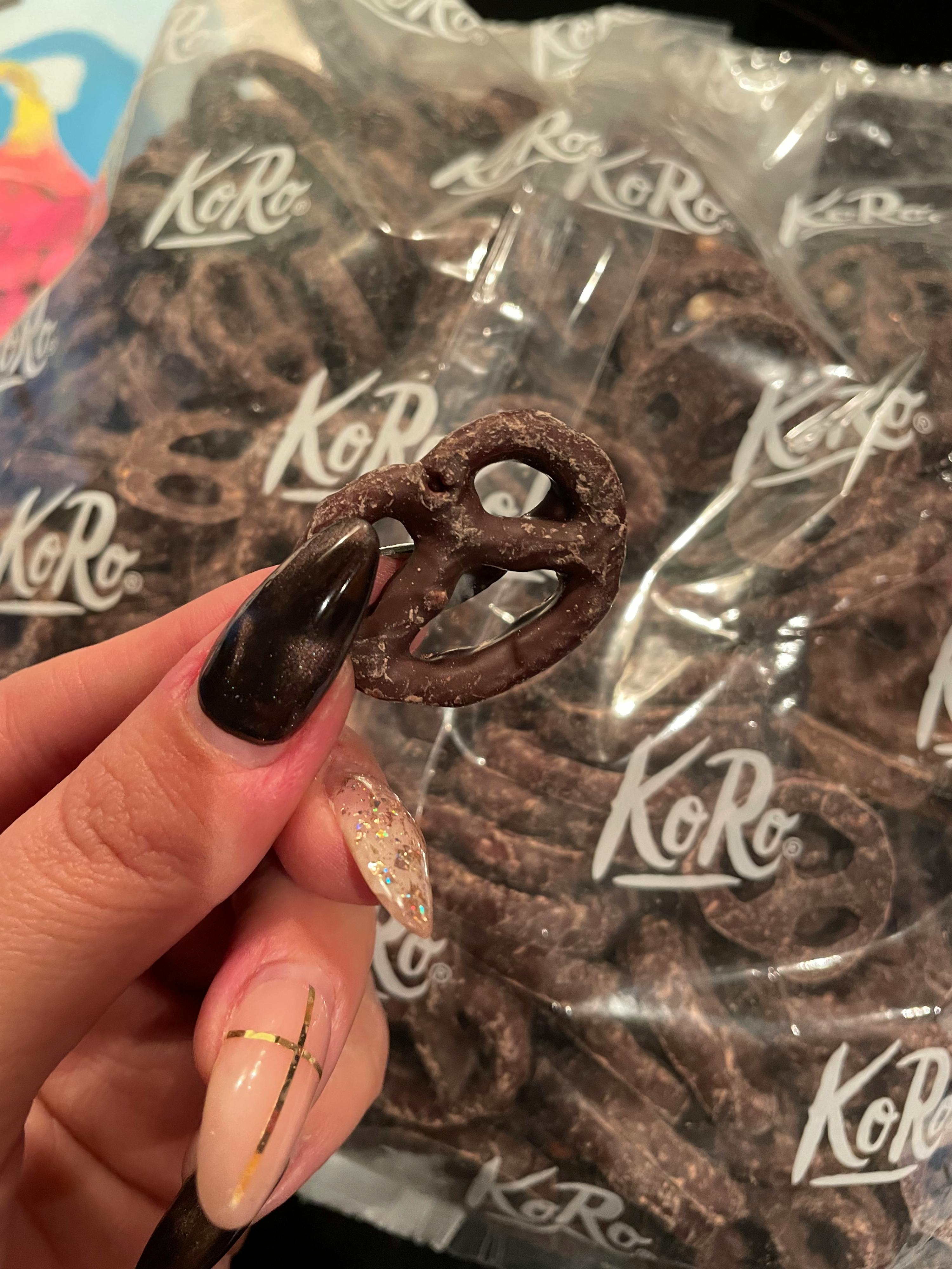 Eine Frau hält einen Schokoladenbrezel in der Hand