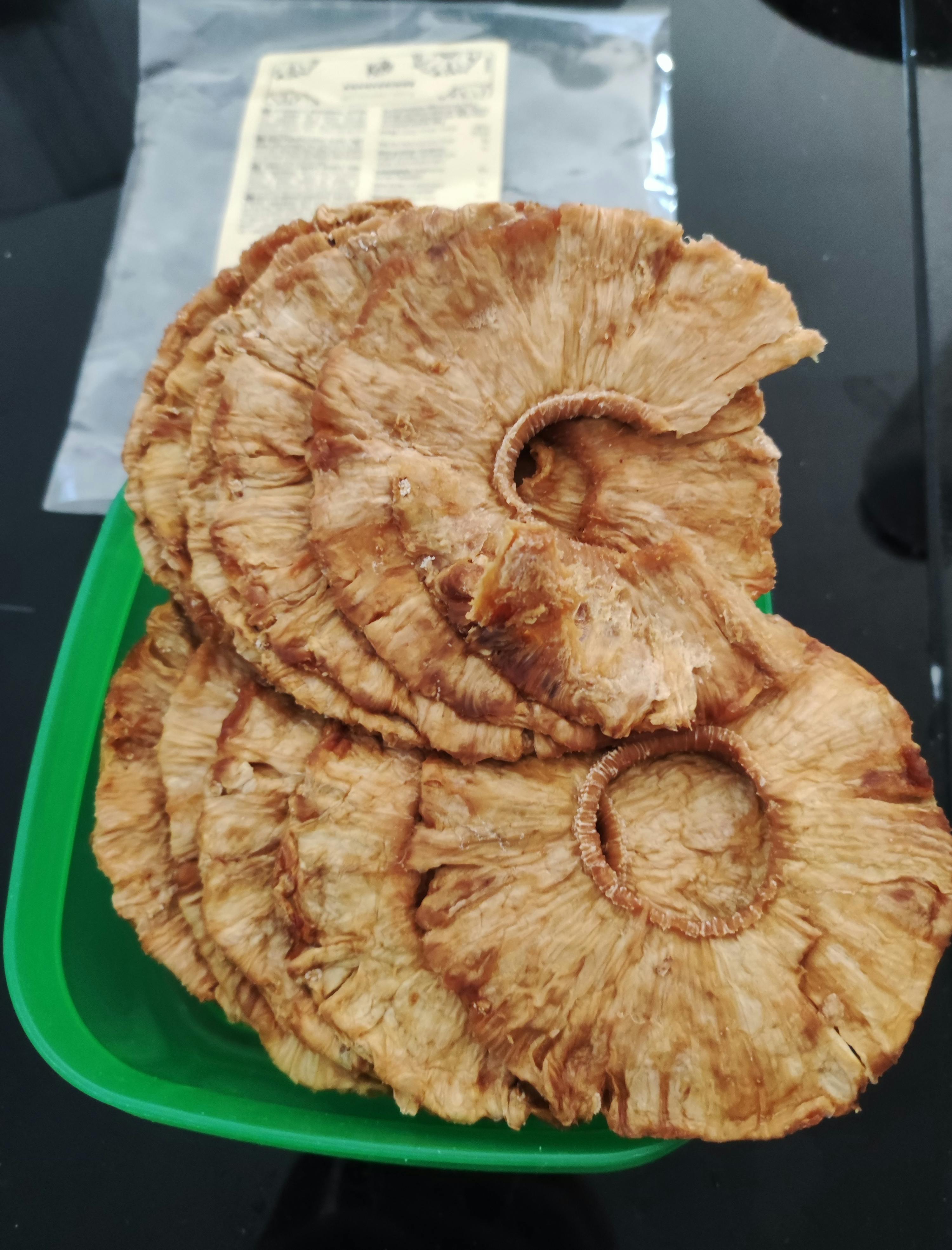 a stack of pineapple slices on a green tray