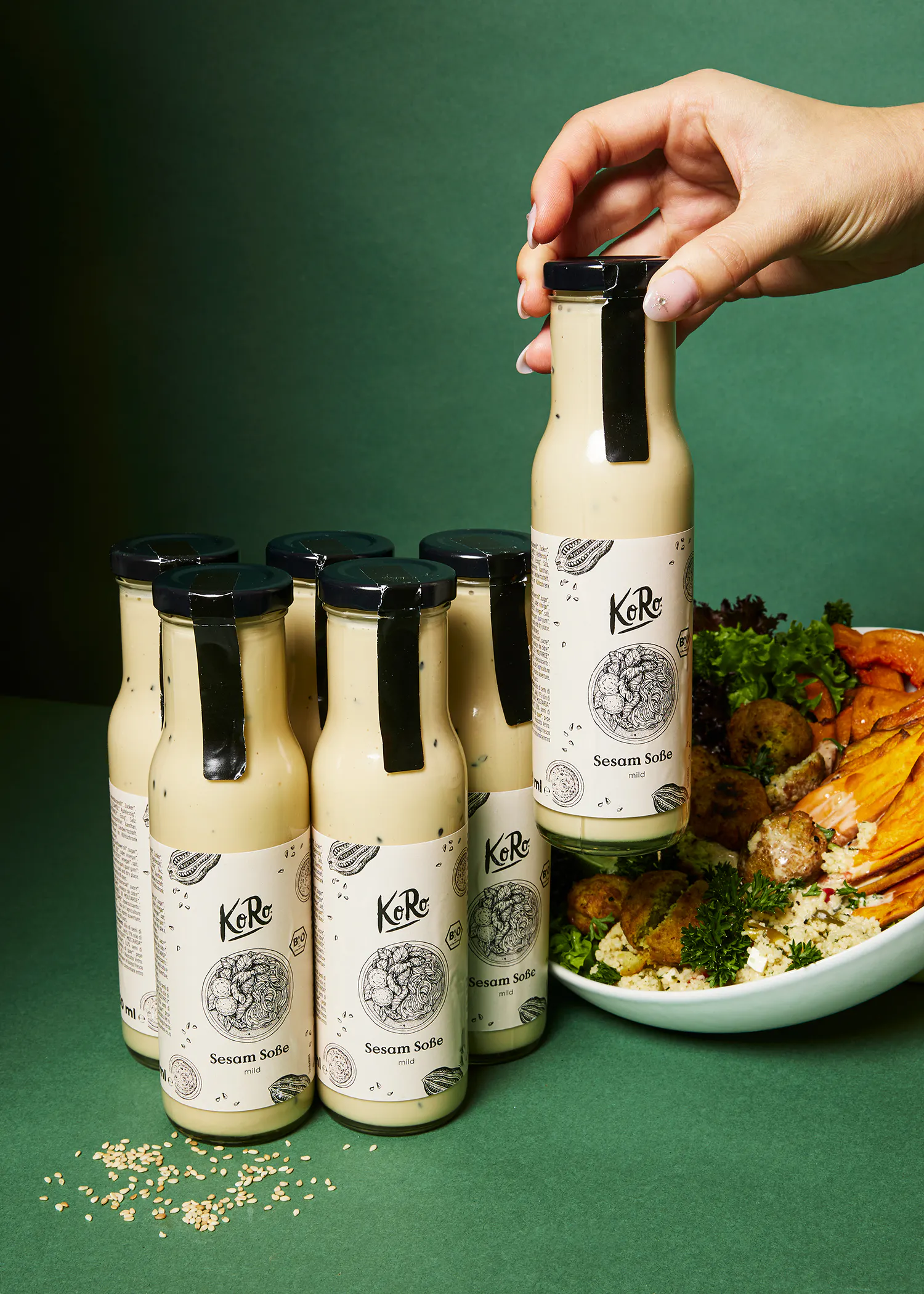 a bottle of sesame sauce is being held in someone 's hand
