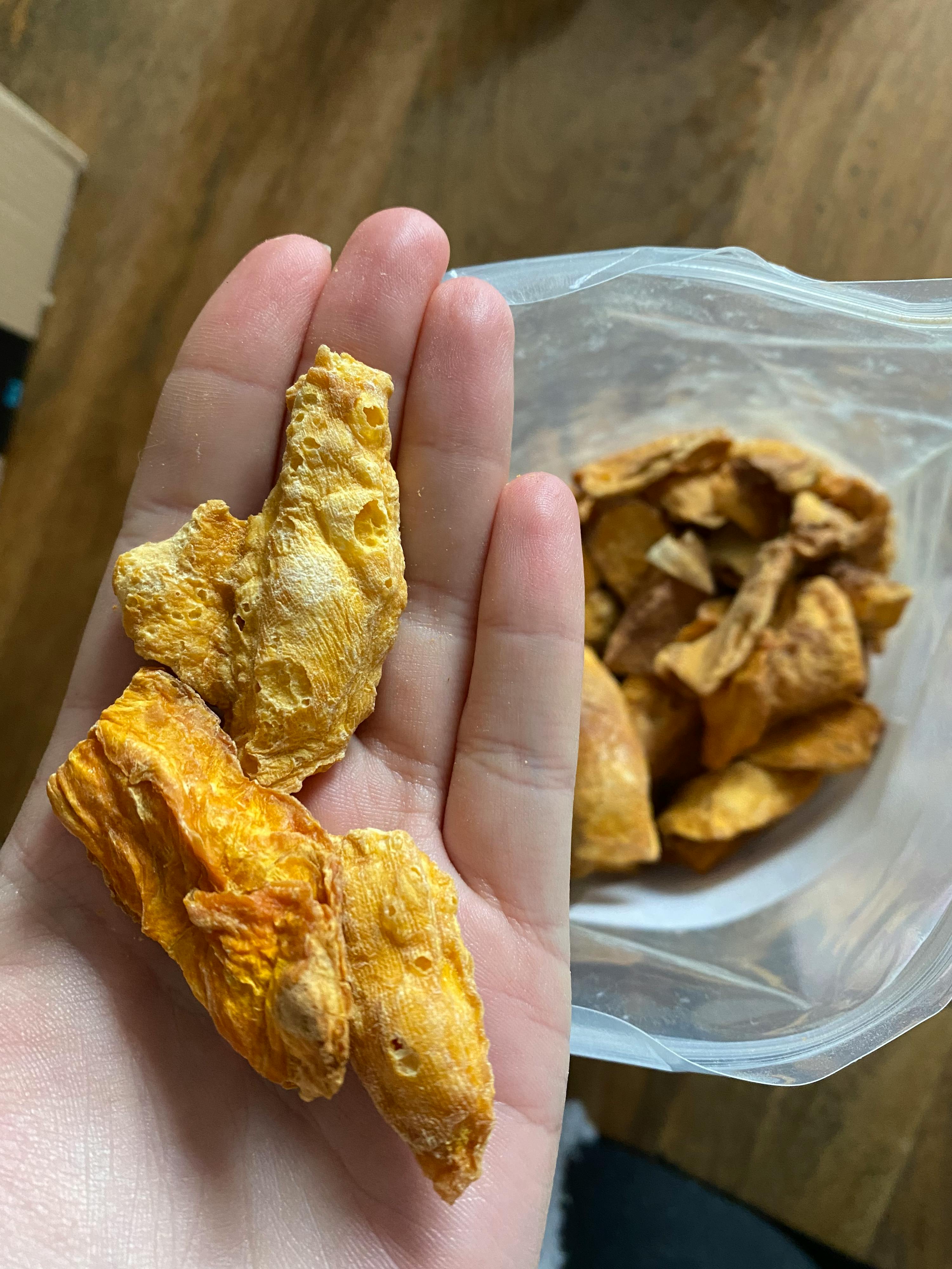 a person holding a piece of food in their hand