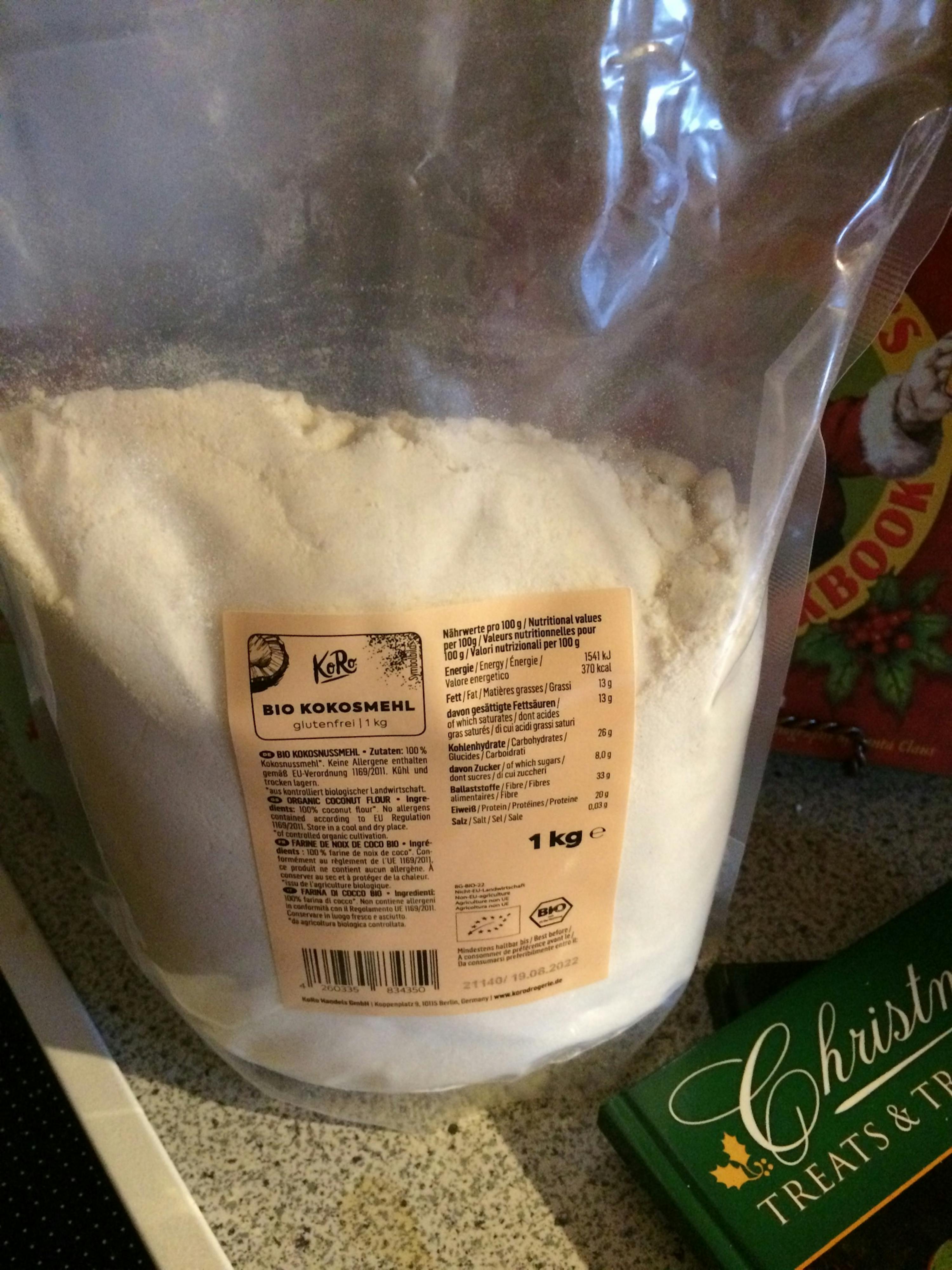 a bag of bio kokosmehl sits on a counter next to a christmas treats & treats book