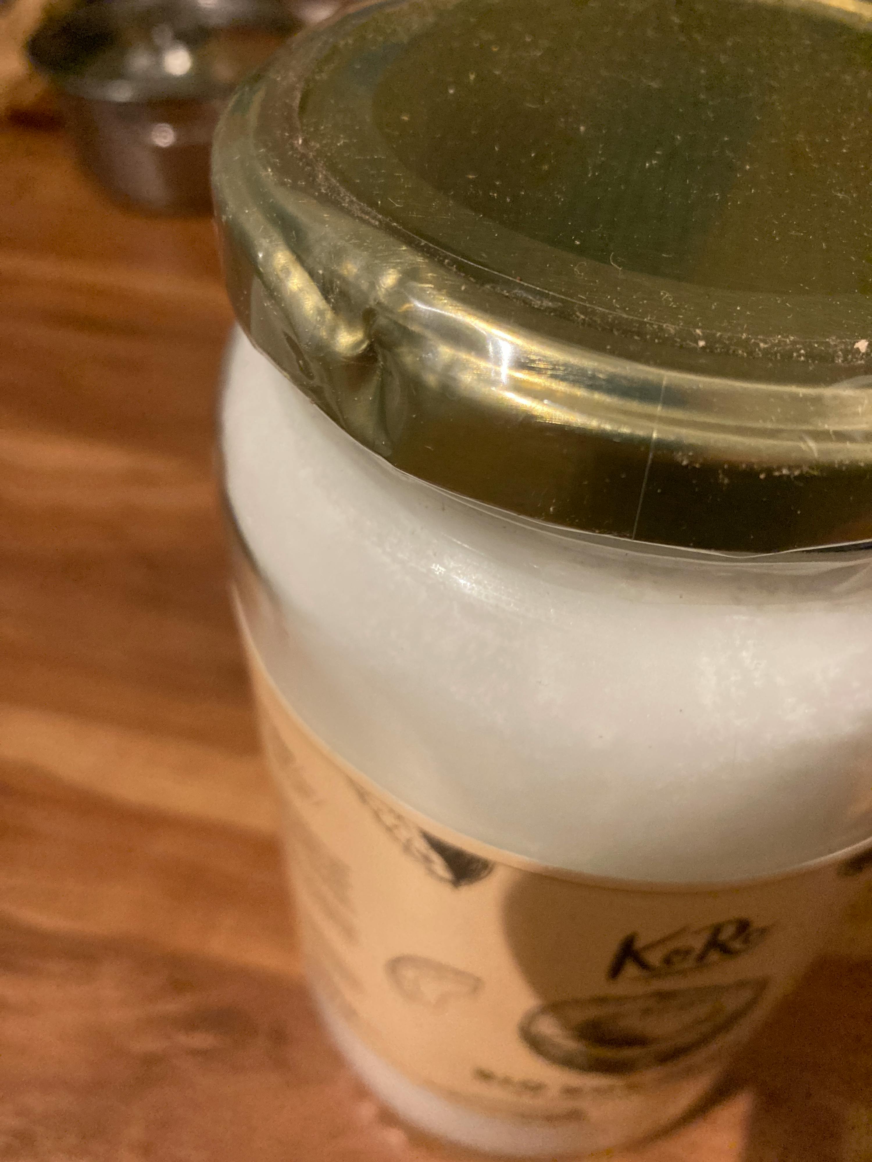 un barattolo di yogurt è seduto su un tavolo di legno