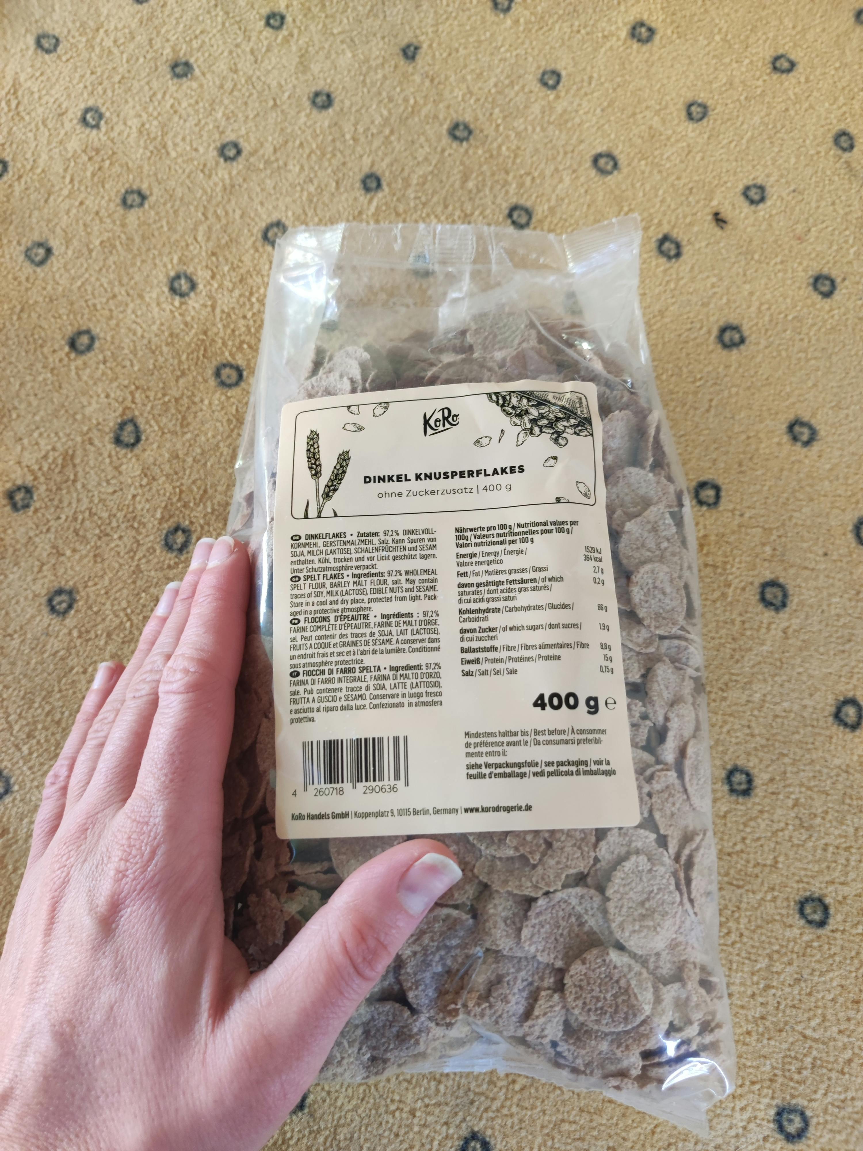 a person holding a bag of dimmel knusperflakes