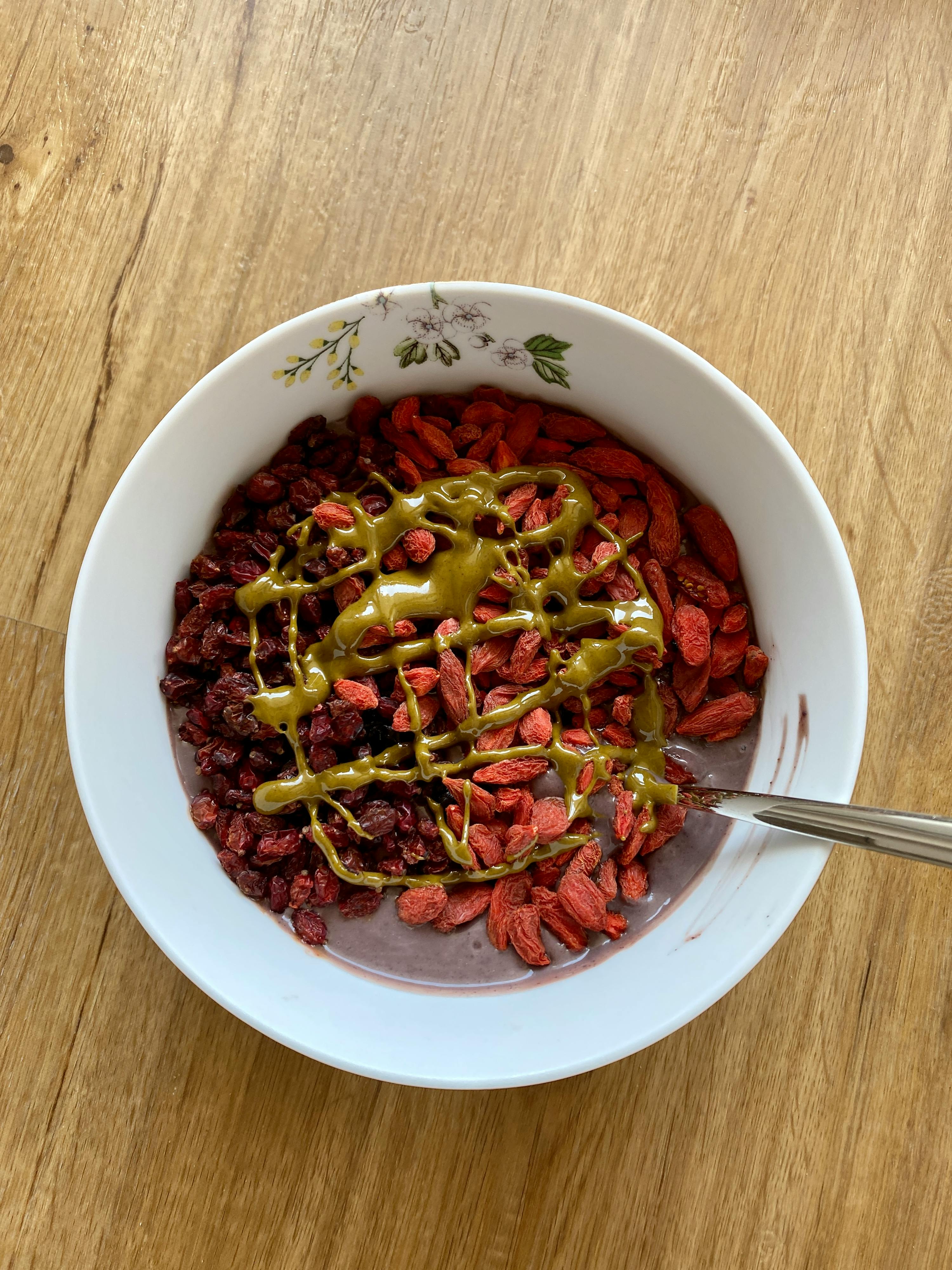 a bowl of cereal with nuts and a spoon in it