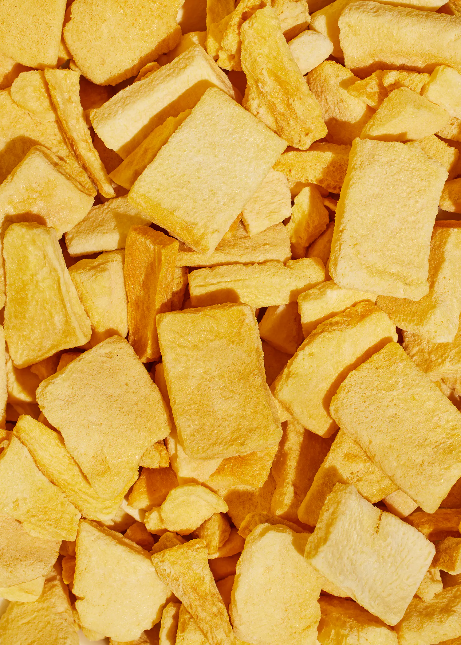 a close up of a pile of yellow squares