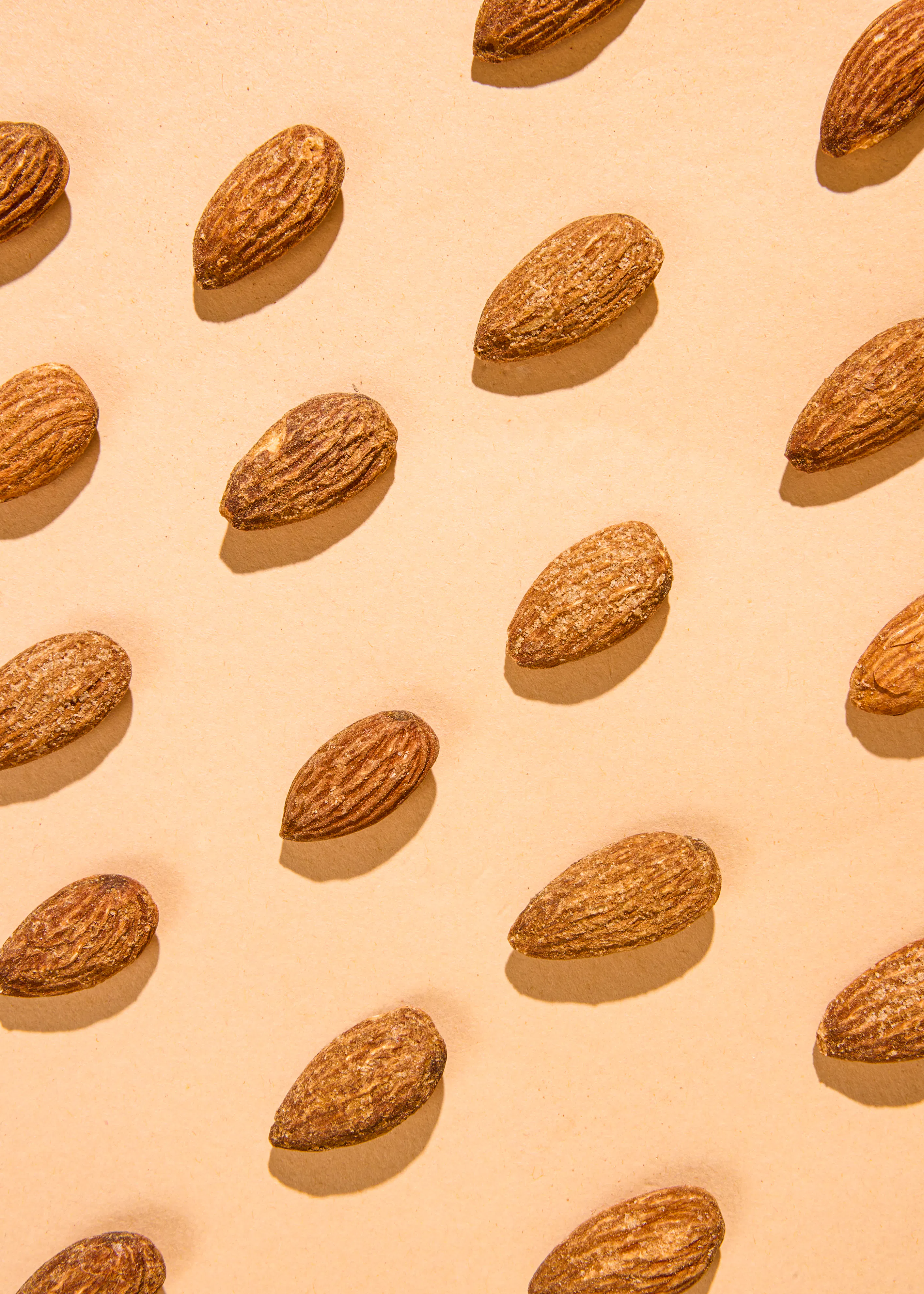 a pattern of almonds on a beige surface