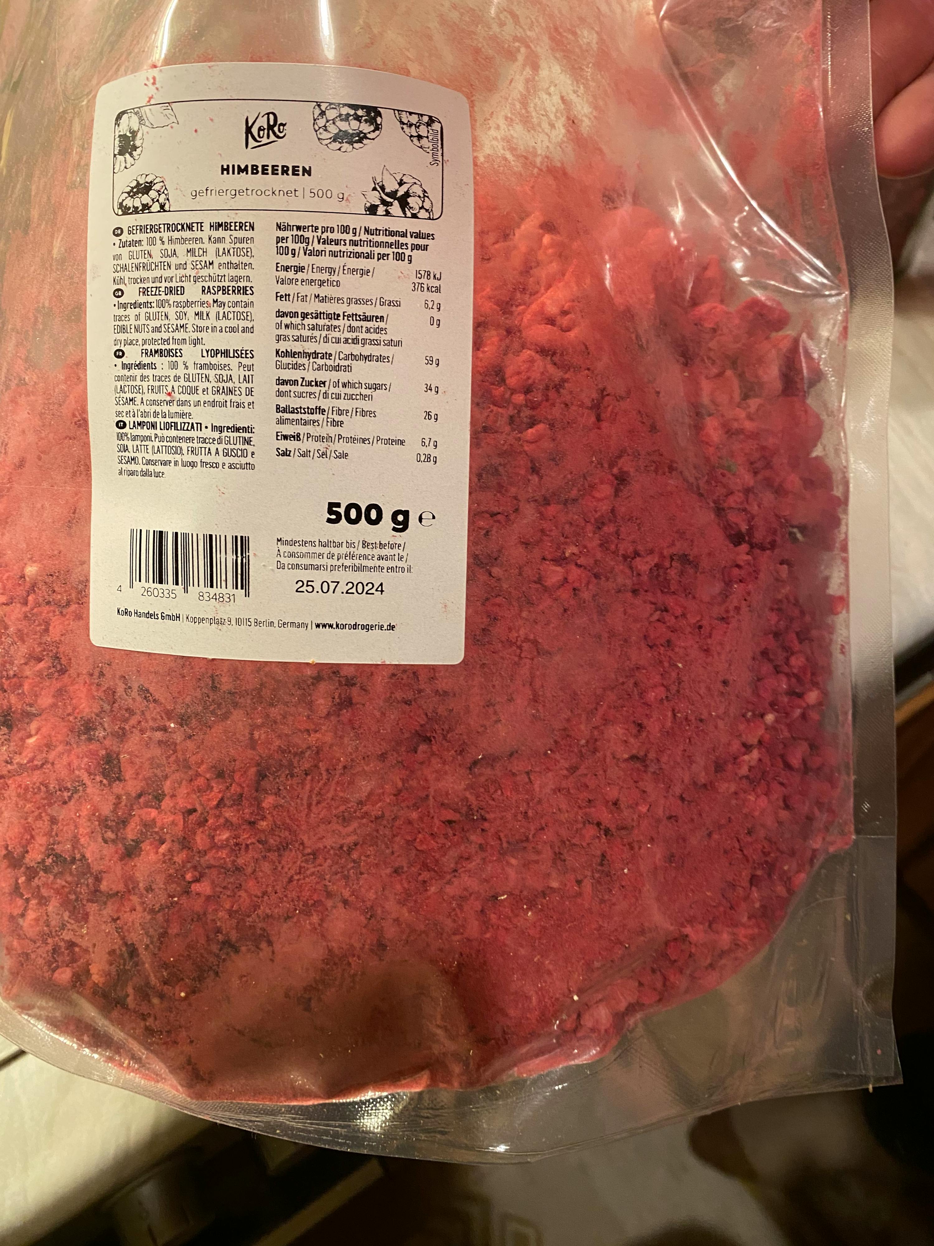 una persona tiene in mano una busta di polvere di lamponi