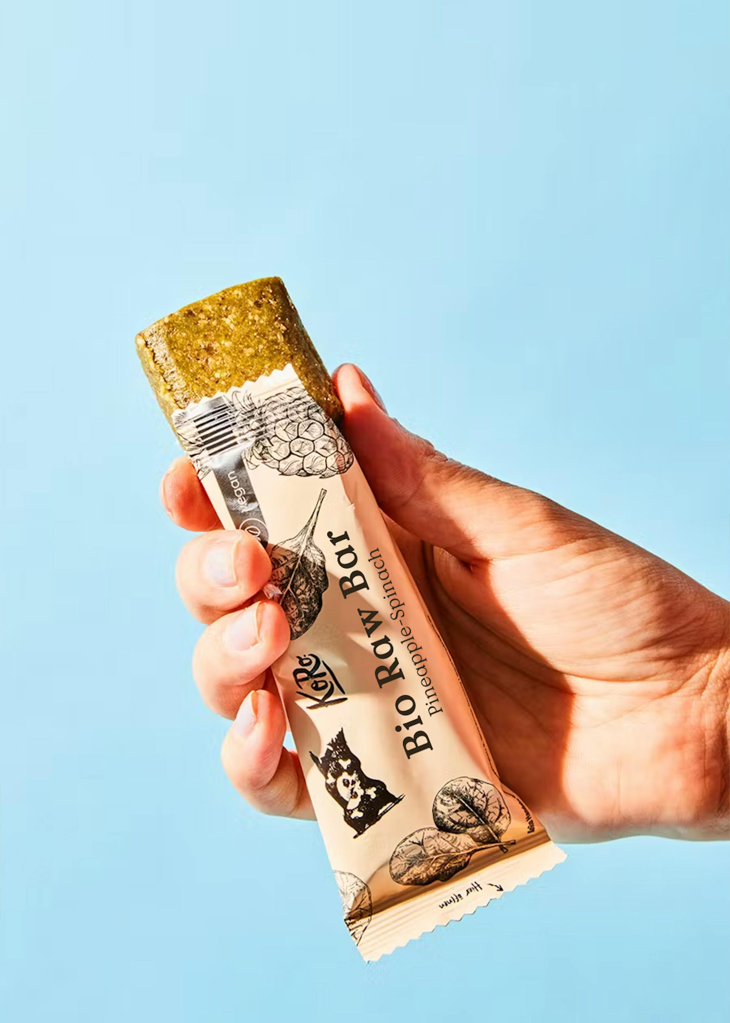 a person holding a bio row bar in their hand