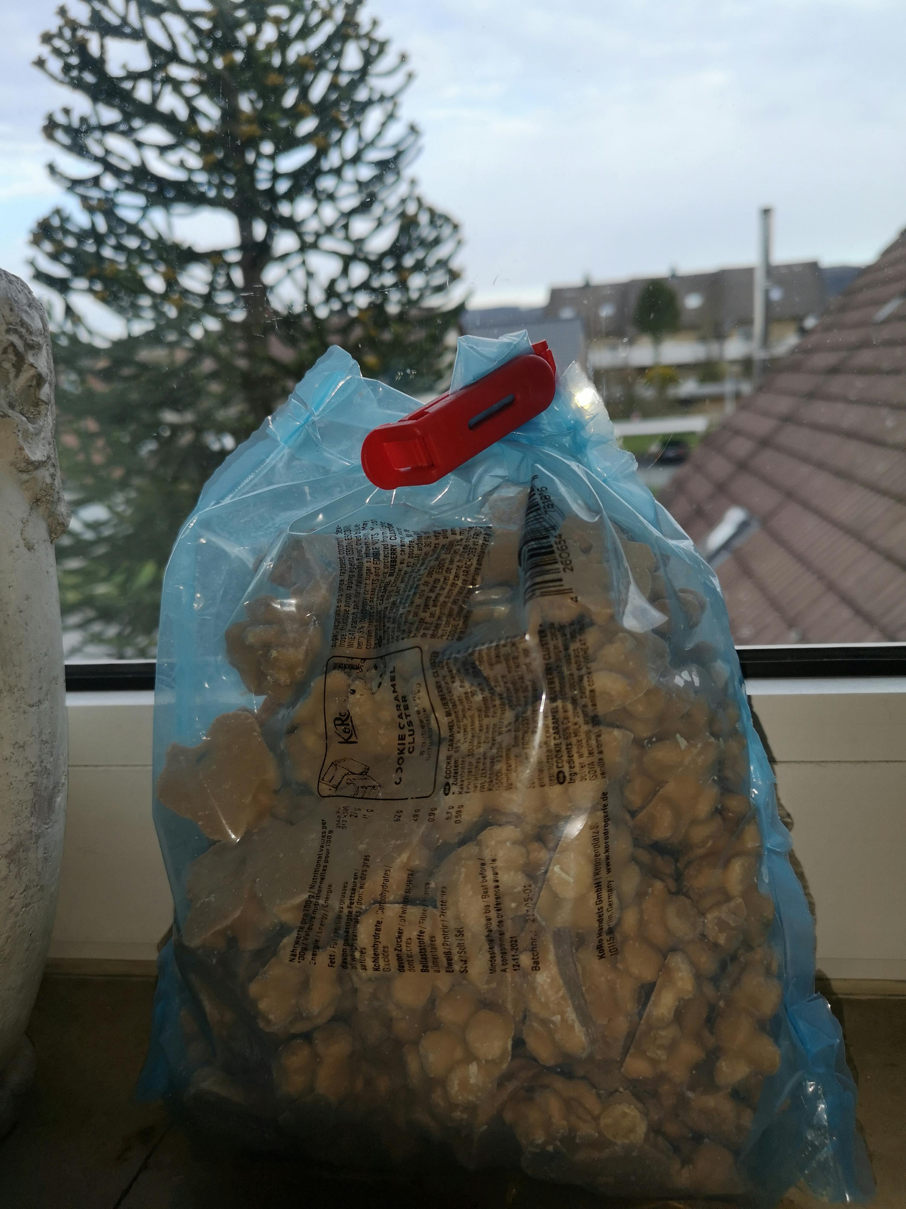 a bag of nuts has a red clip attached to it