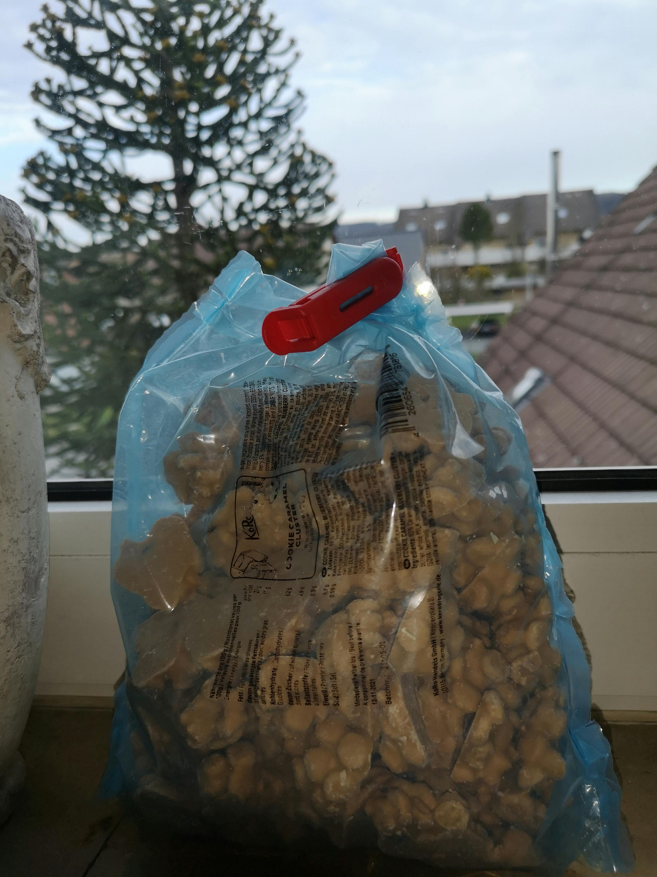 a bag of nuts has a red clip attached to it