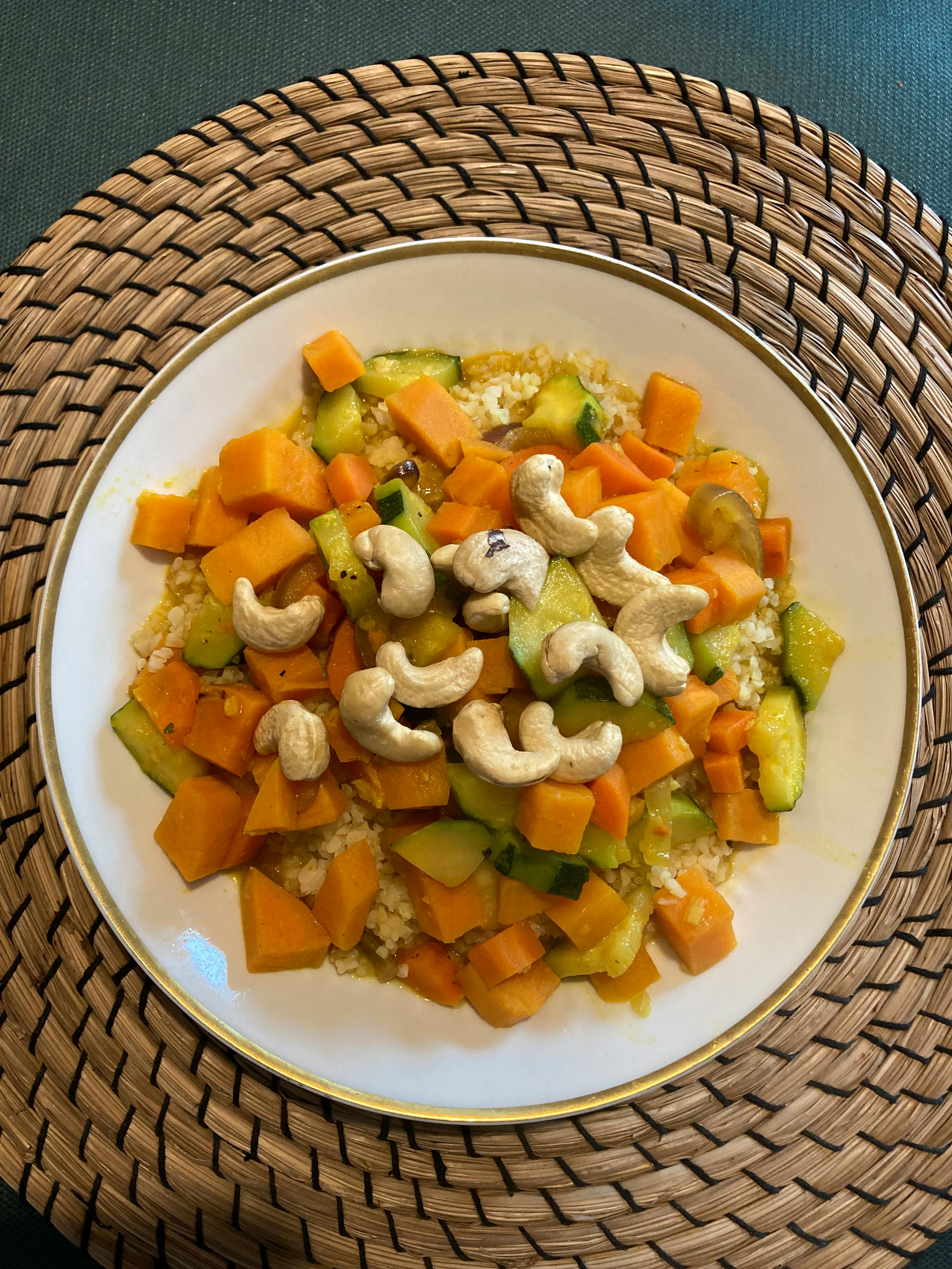 une assiette de nourriture avec des carottes et des noix de cajou