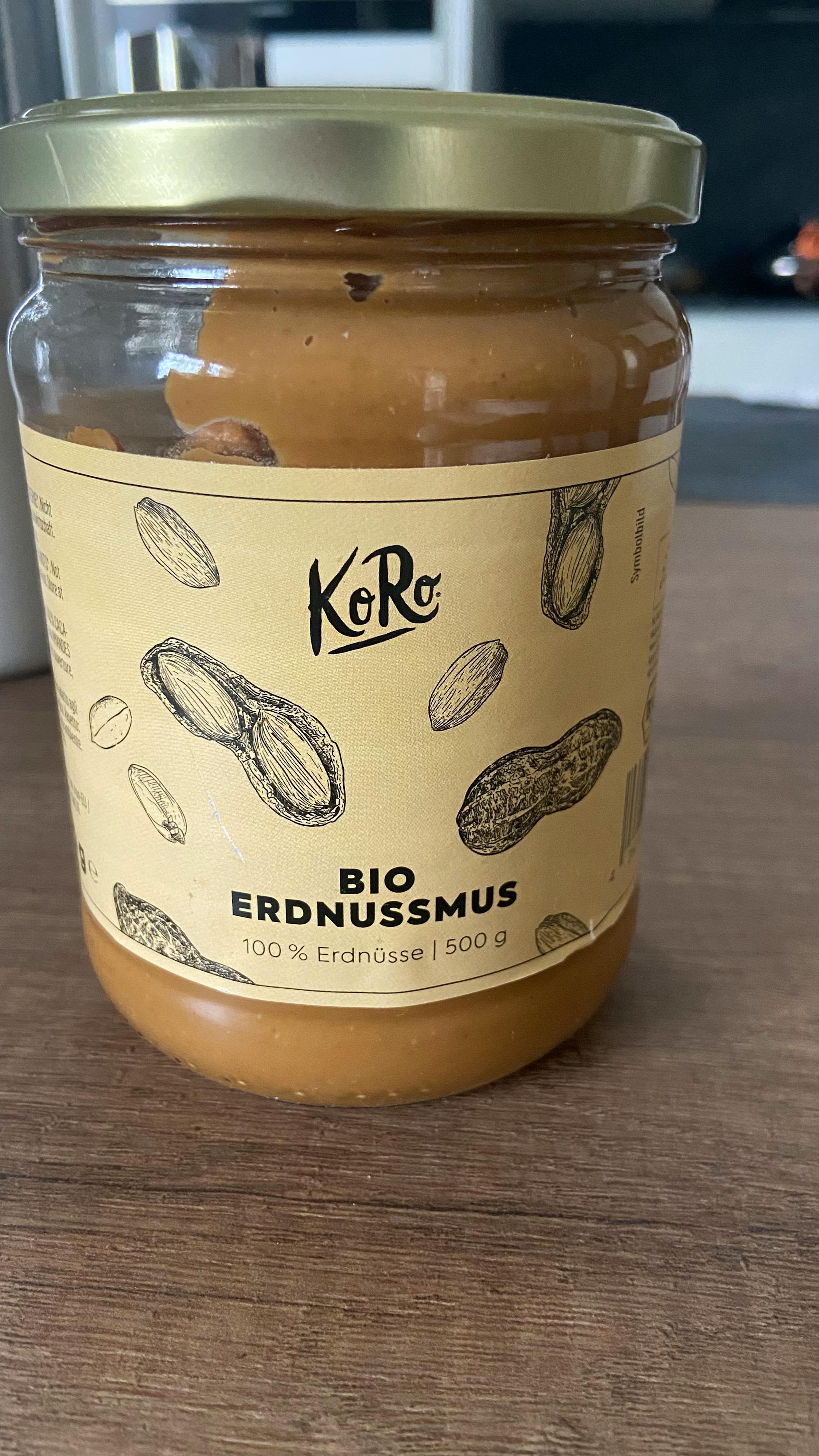 a jar of bio erdnussmus is on a wooden table
