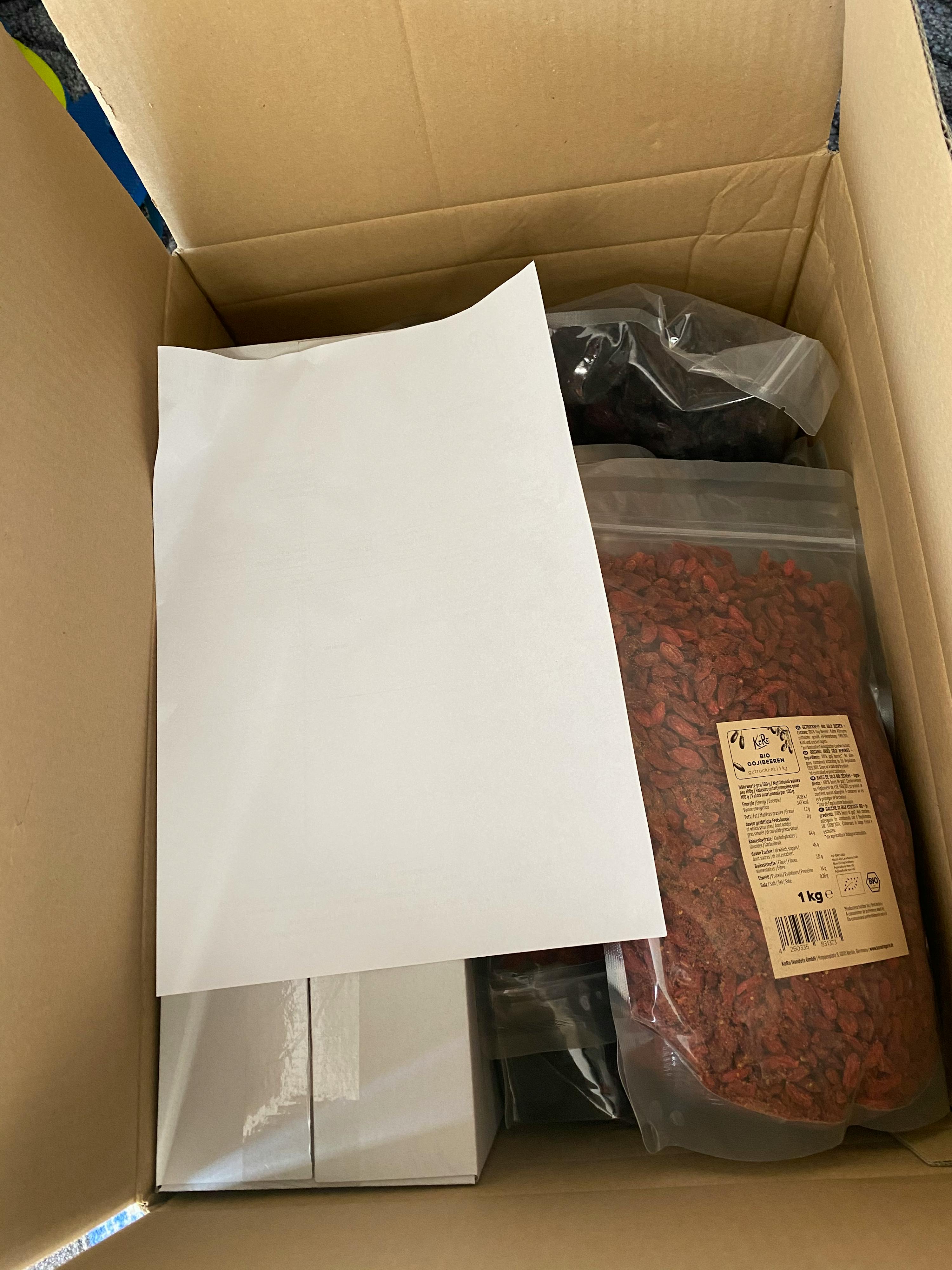 a bag of goji berries is in a cardboard box