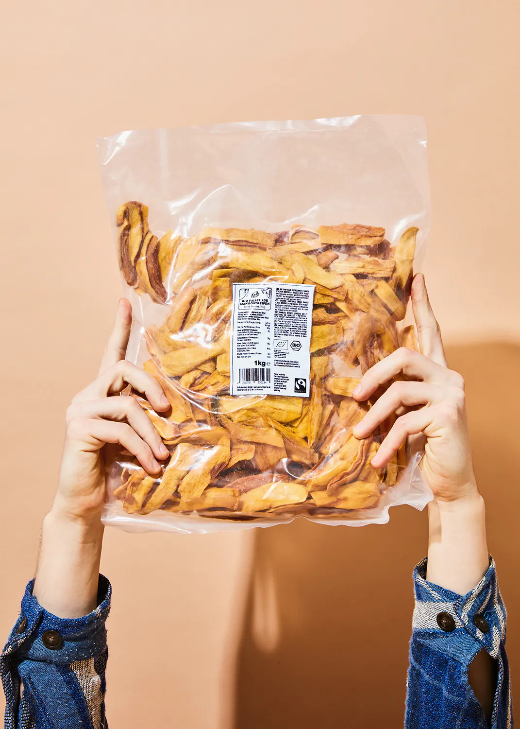 une personne tient un sac de bananes séchées