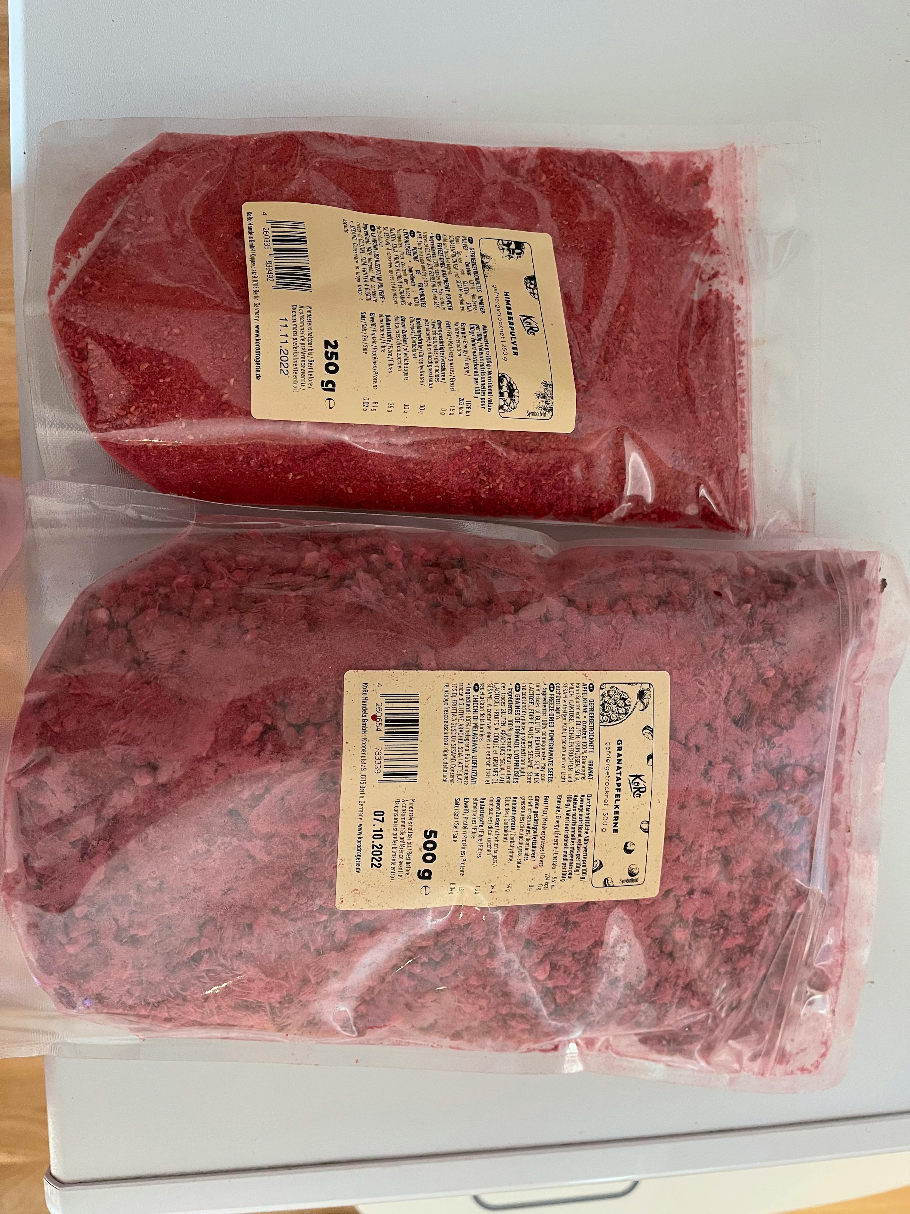 two bags of red powder are sitting on a counter