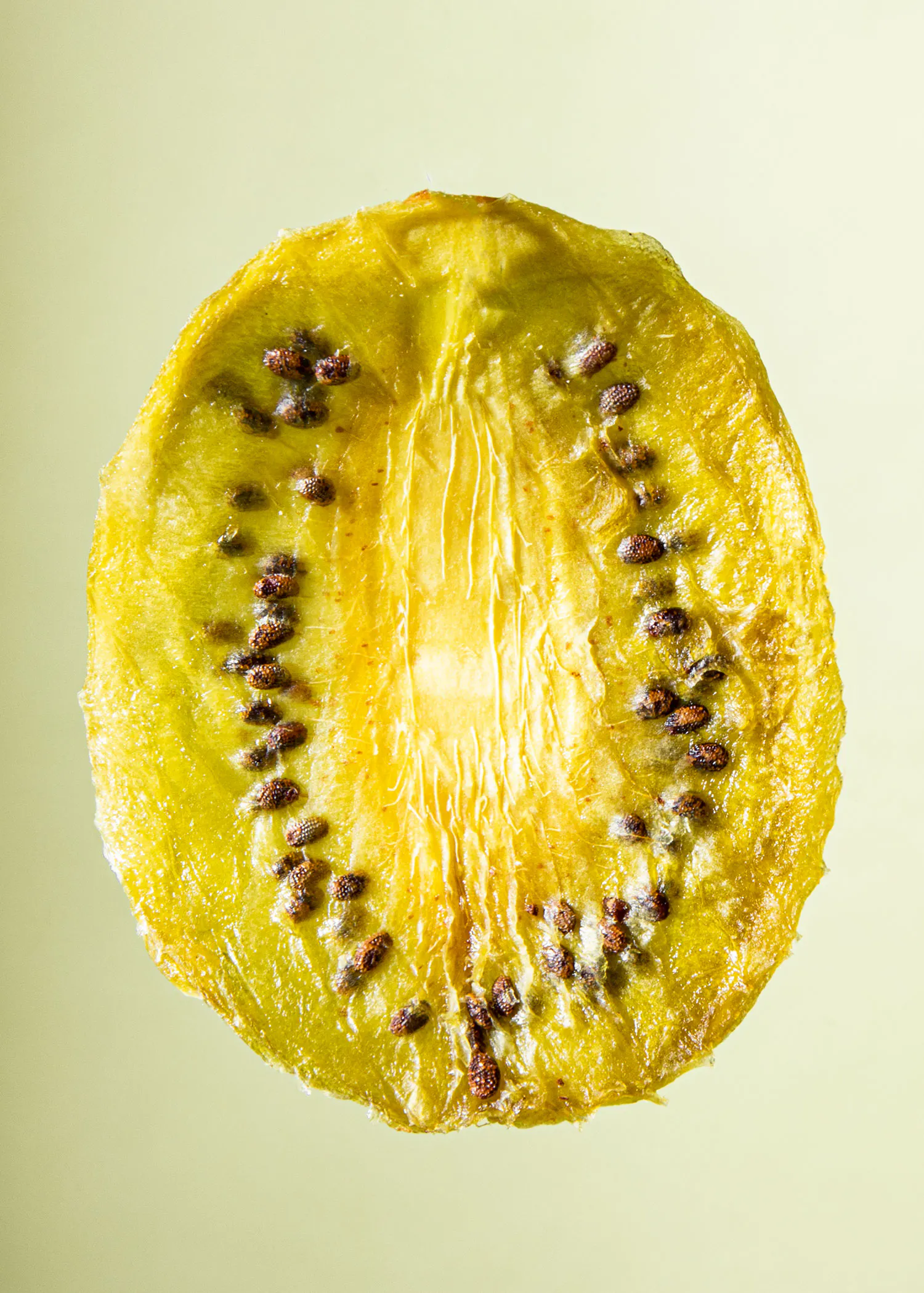 une tranche de kiwi jaune avec des graines brunes