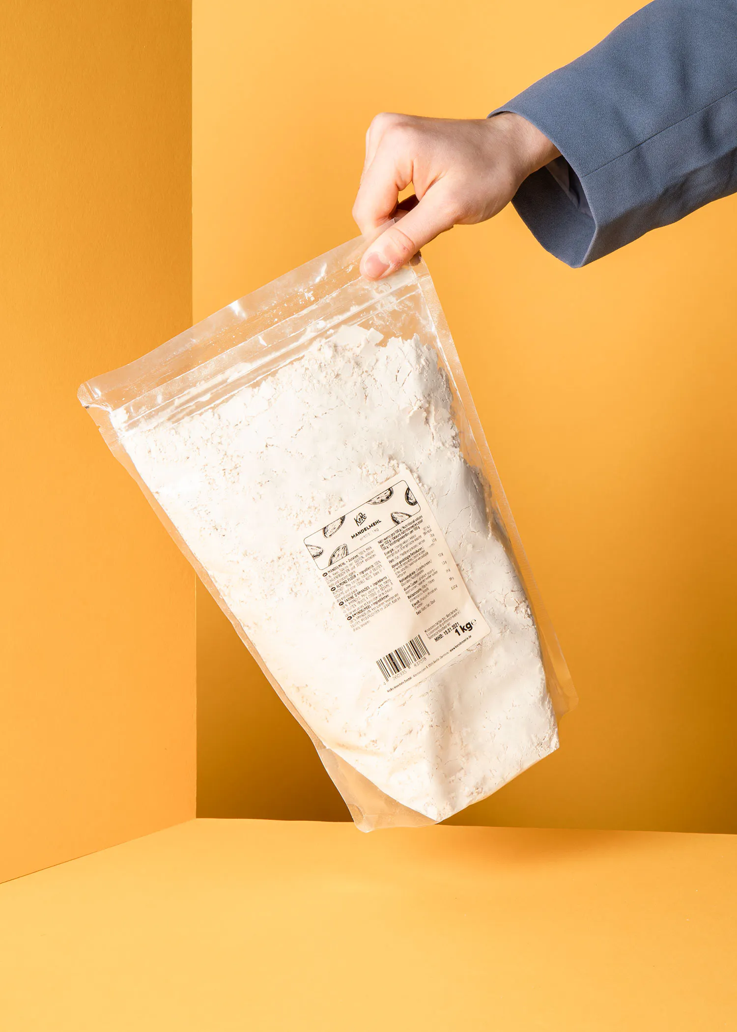 a person is holding a bag of flour with a label on it