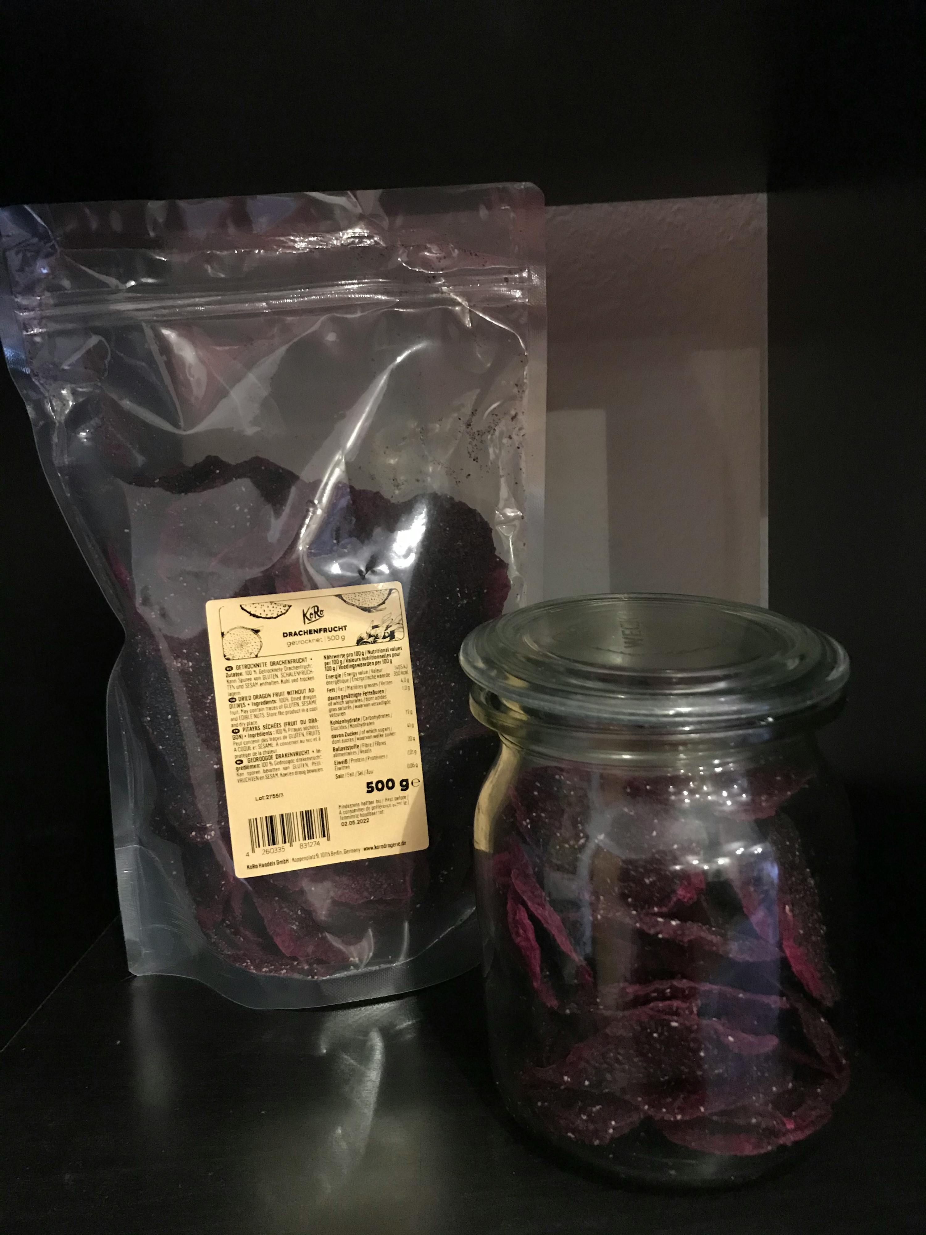a jar of purple chips sits next to a bag of chips