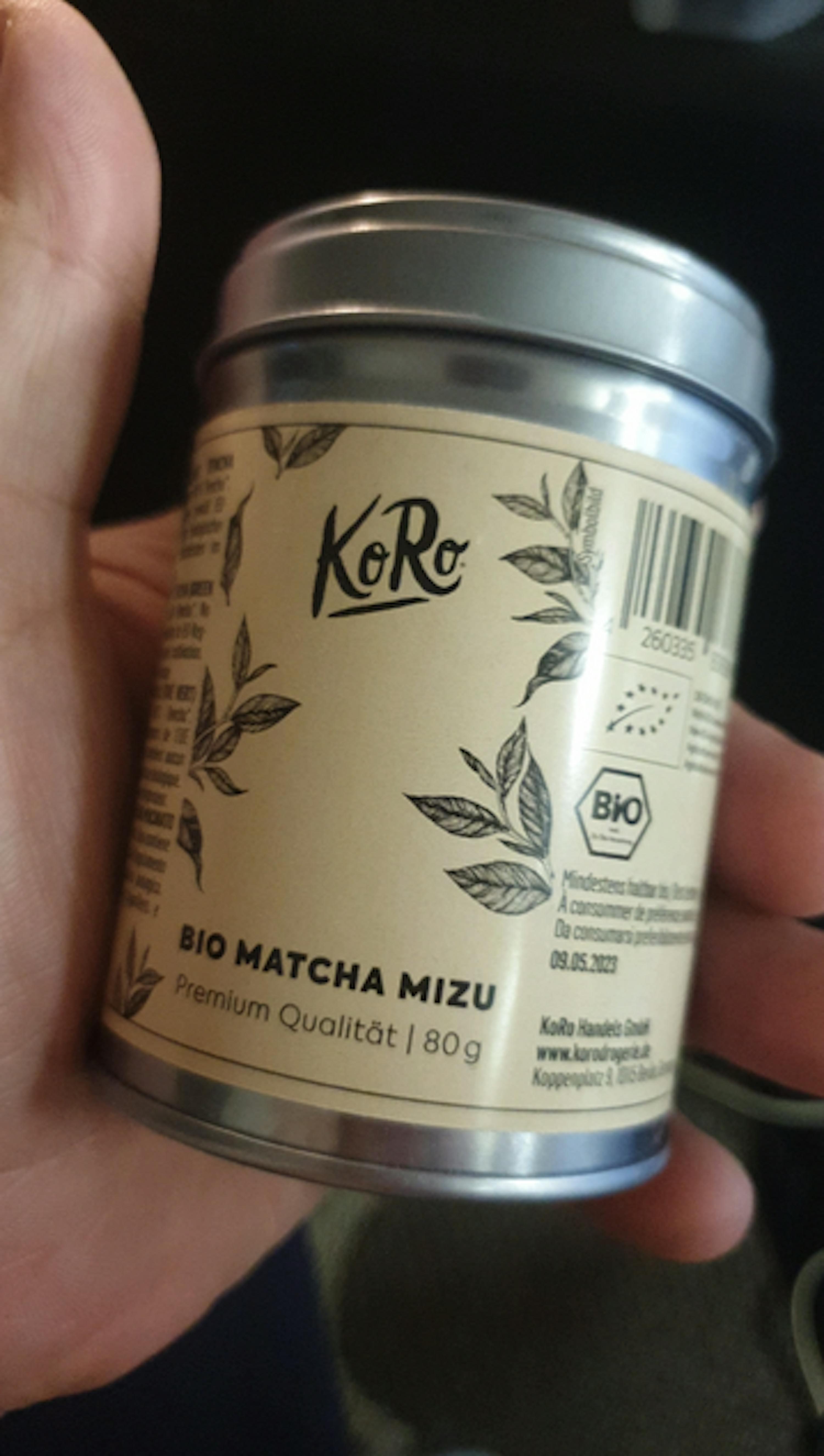 a hand is holding a can of bio matcha mizu