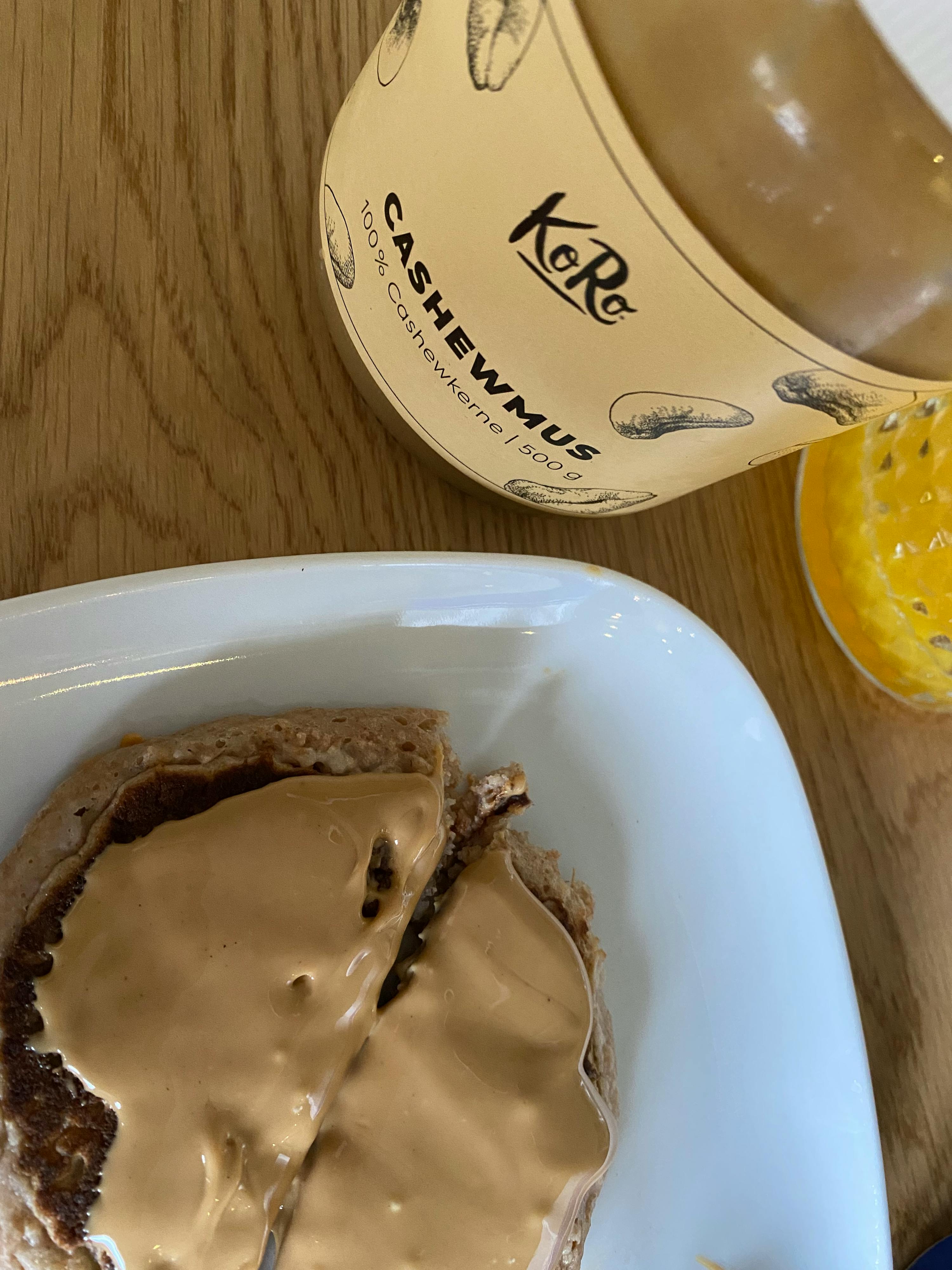 a bottle of cashewmus sits next to a plate of food