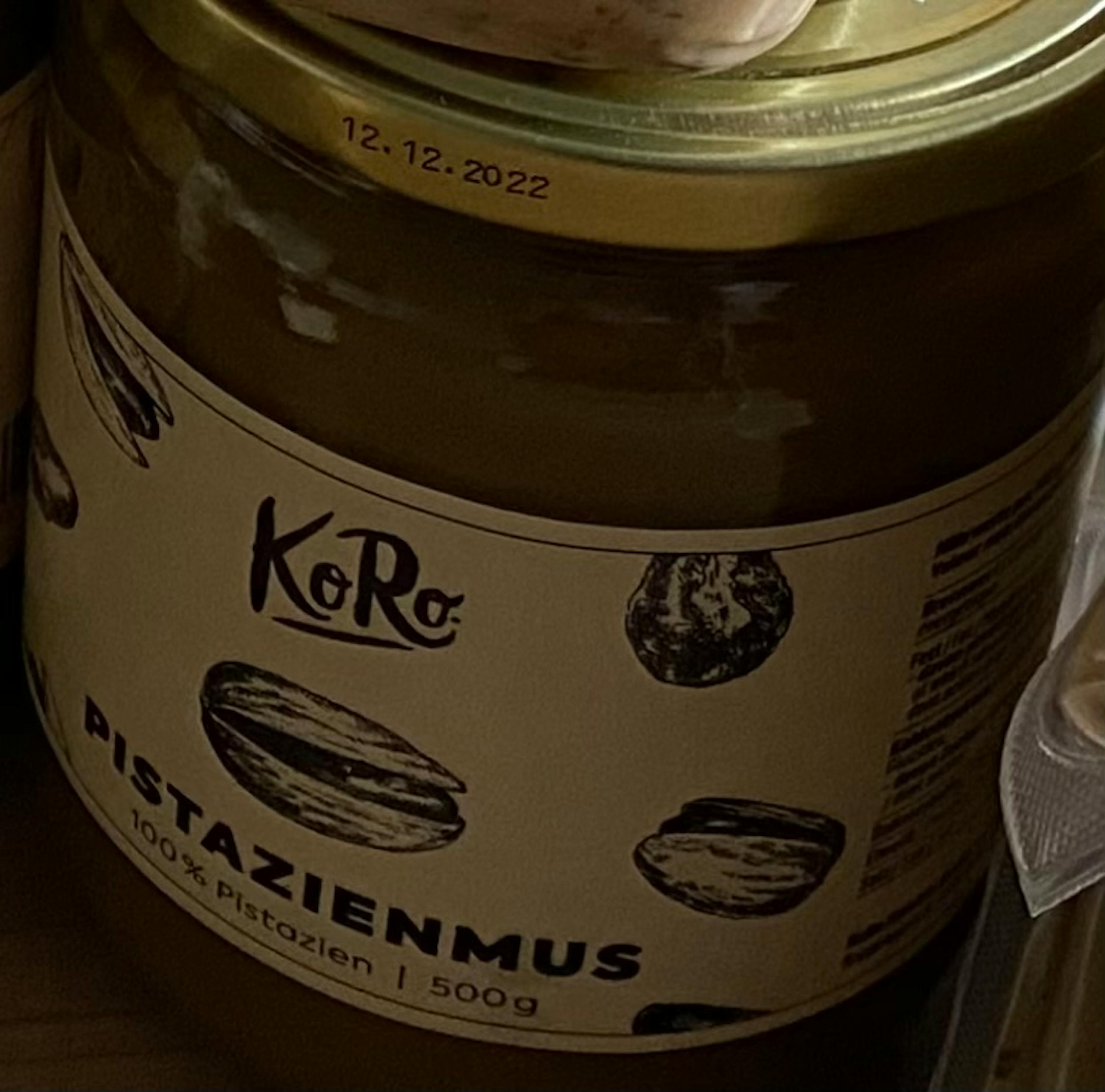 a close up of a jar of pistazienmus from koro