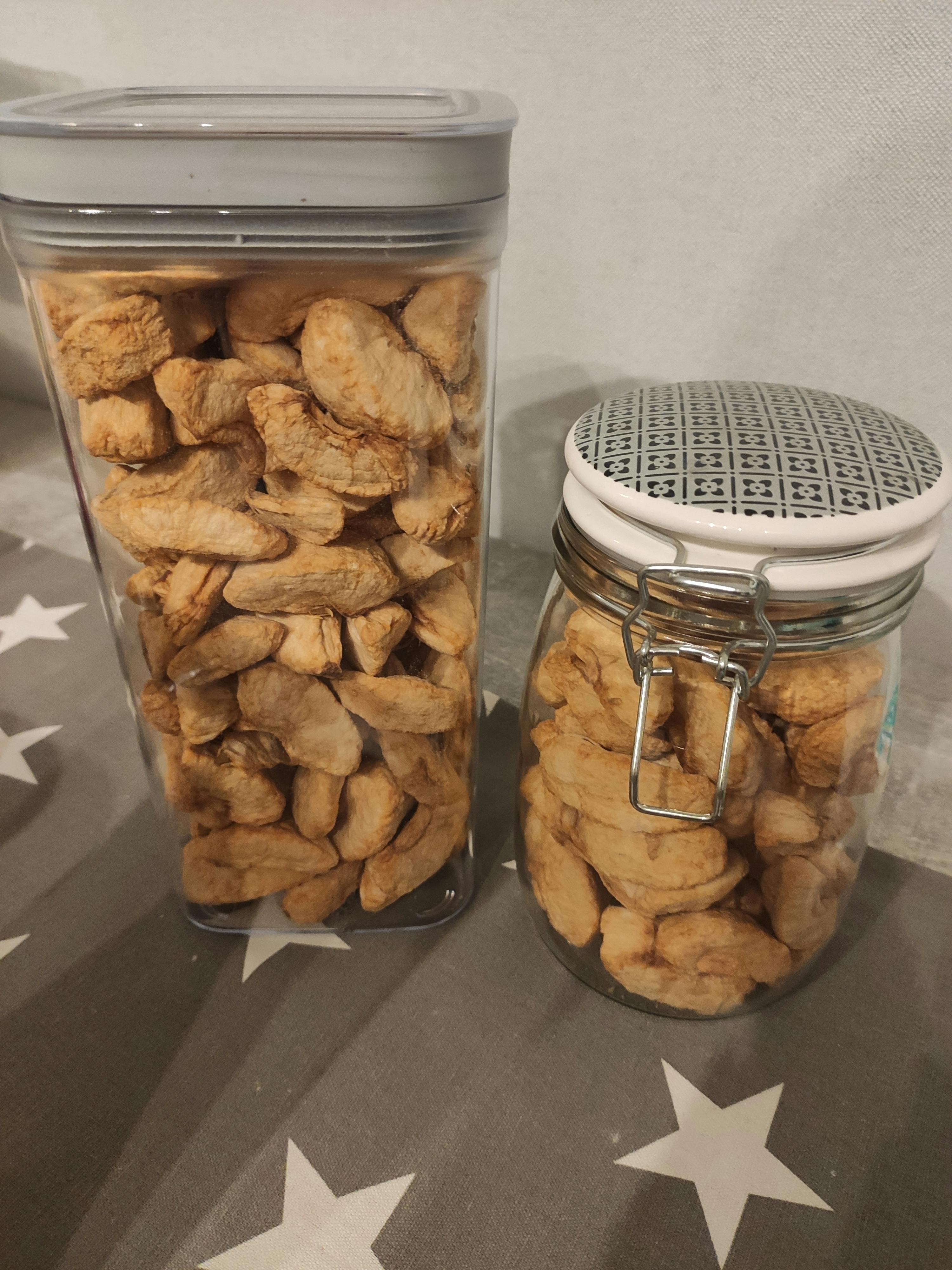 two jars filled with nuts sit on a table with stars