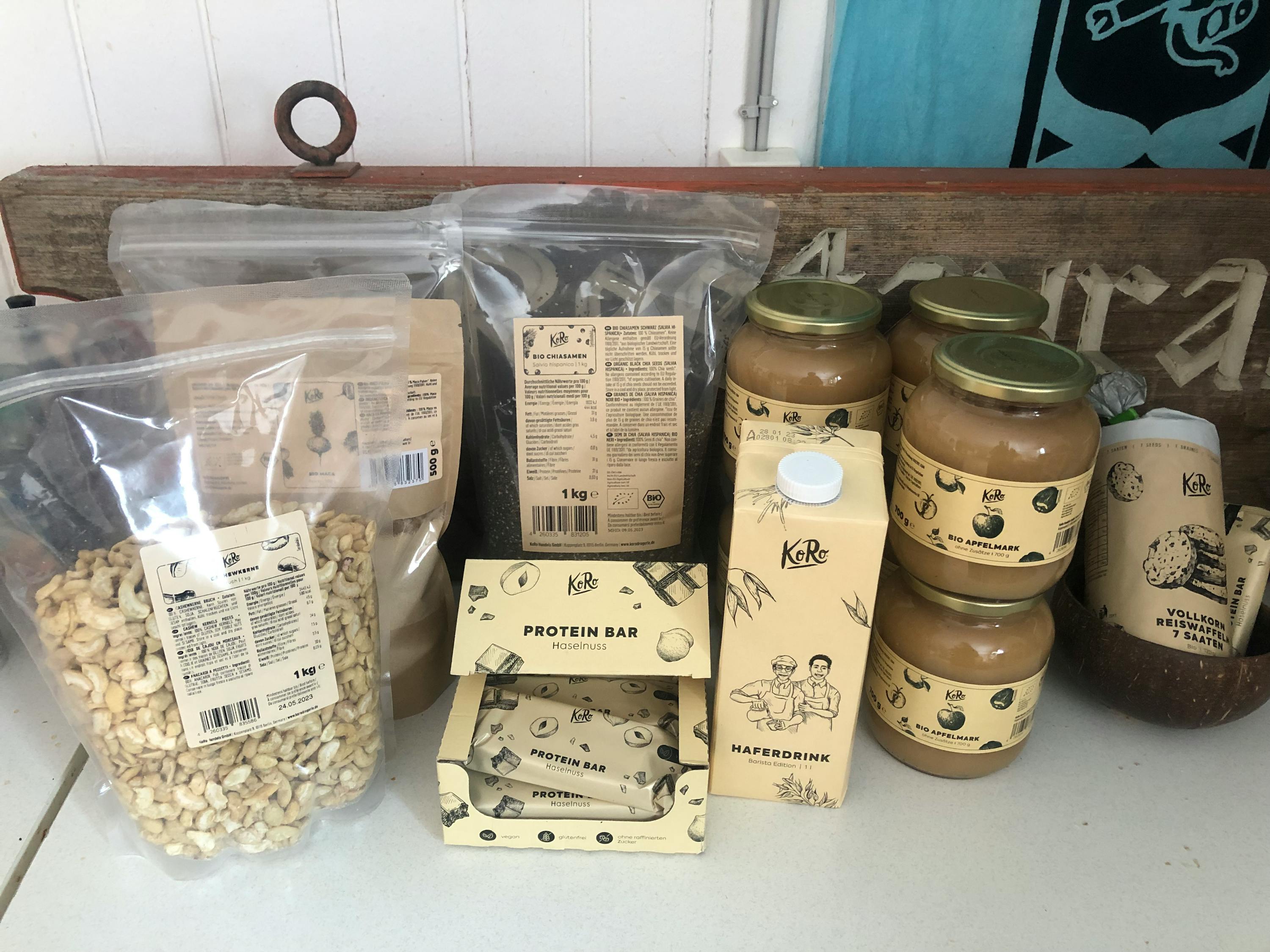 a box of protein bar sits on a table next to other items