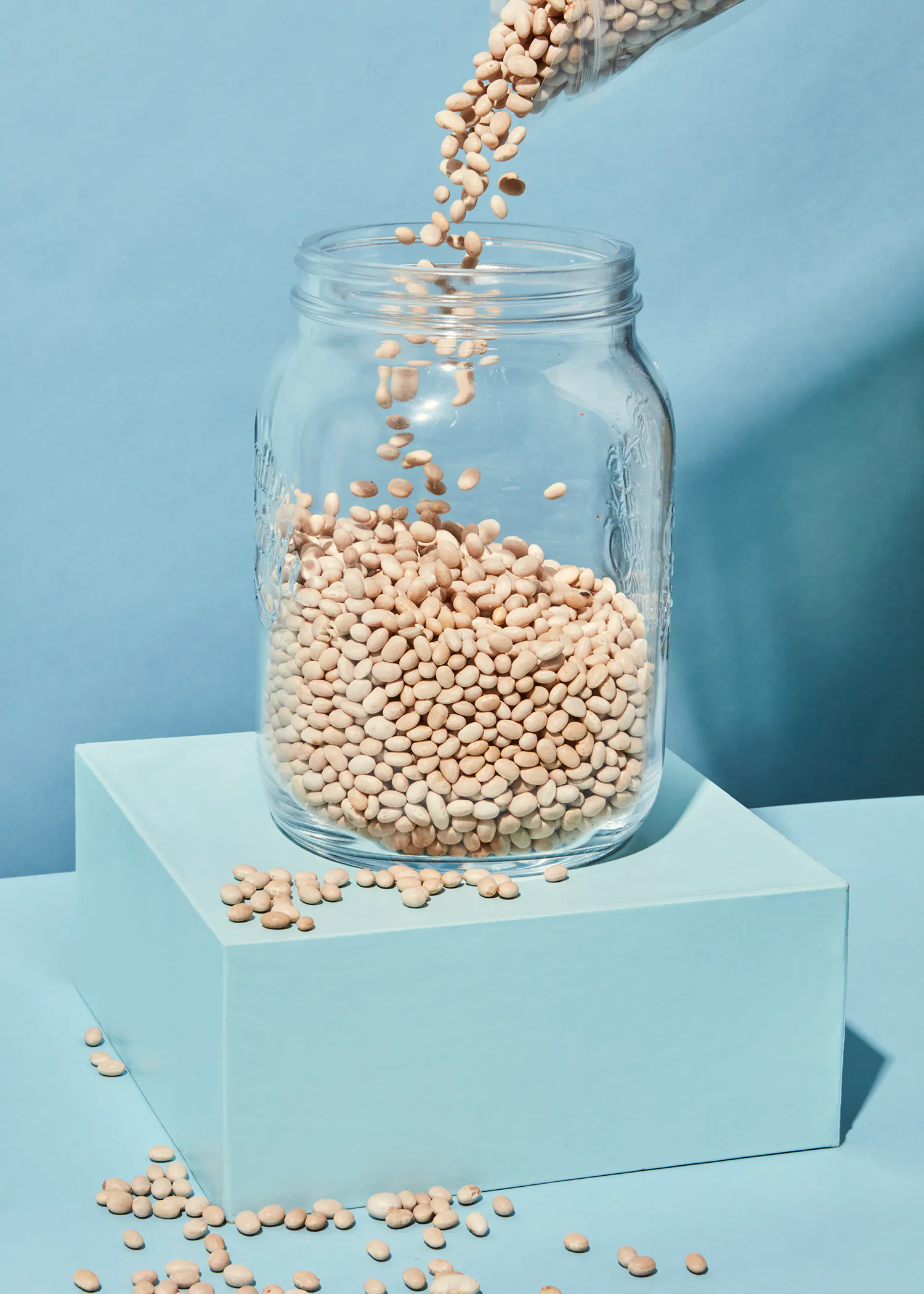 a jar of beans is being poured into it