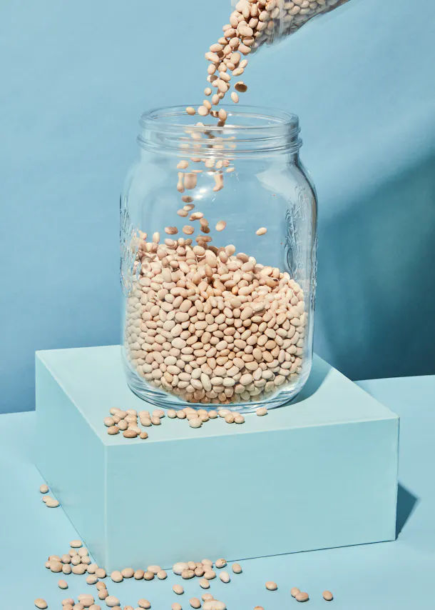 a jar of beans is being poured into it