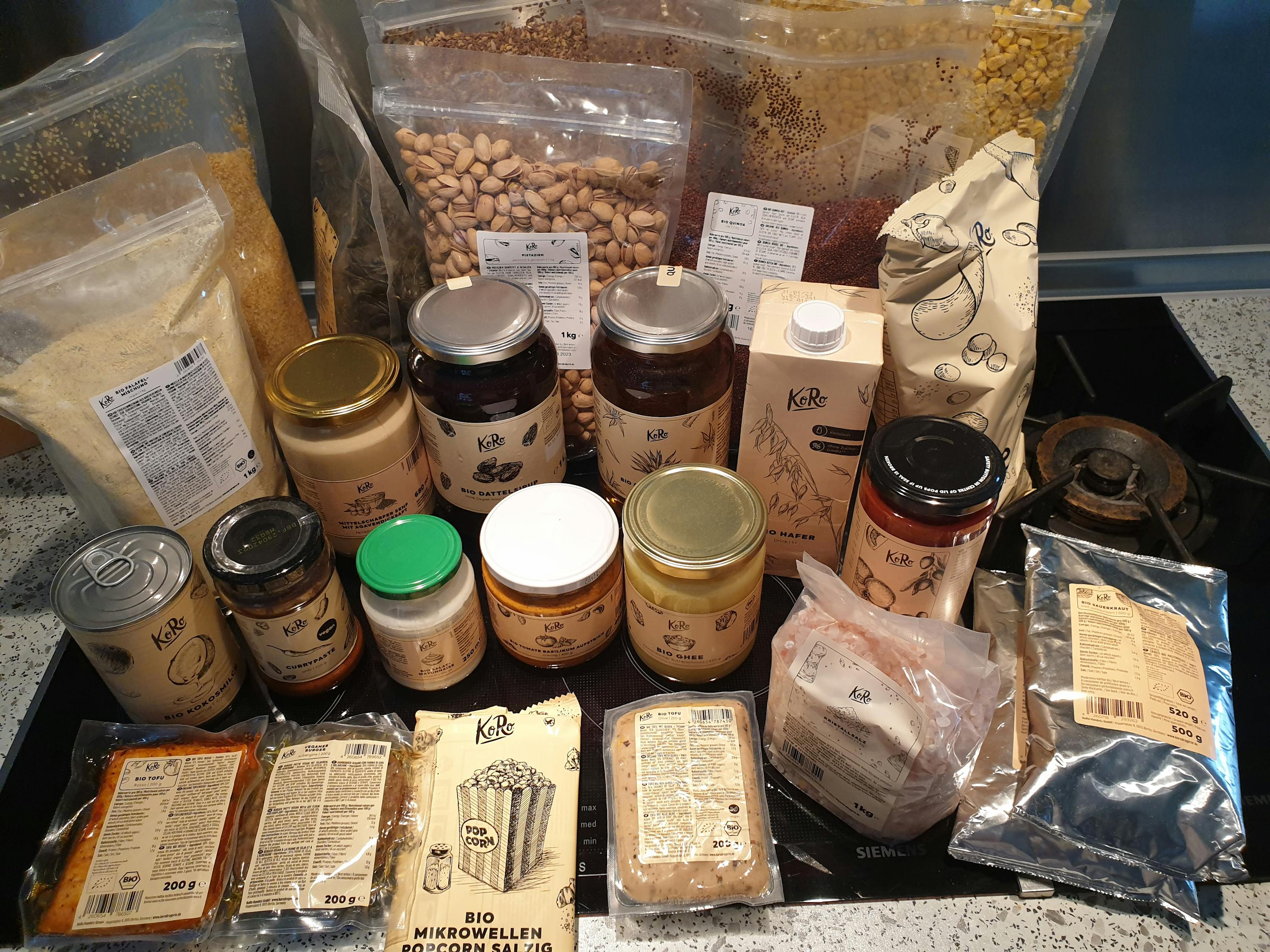 a variety of food items including a bag of kale