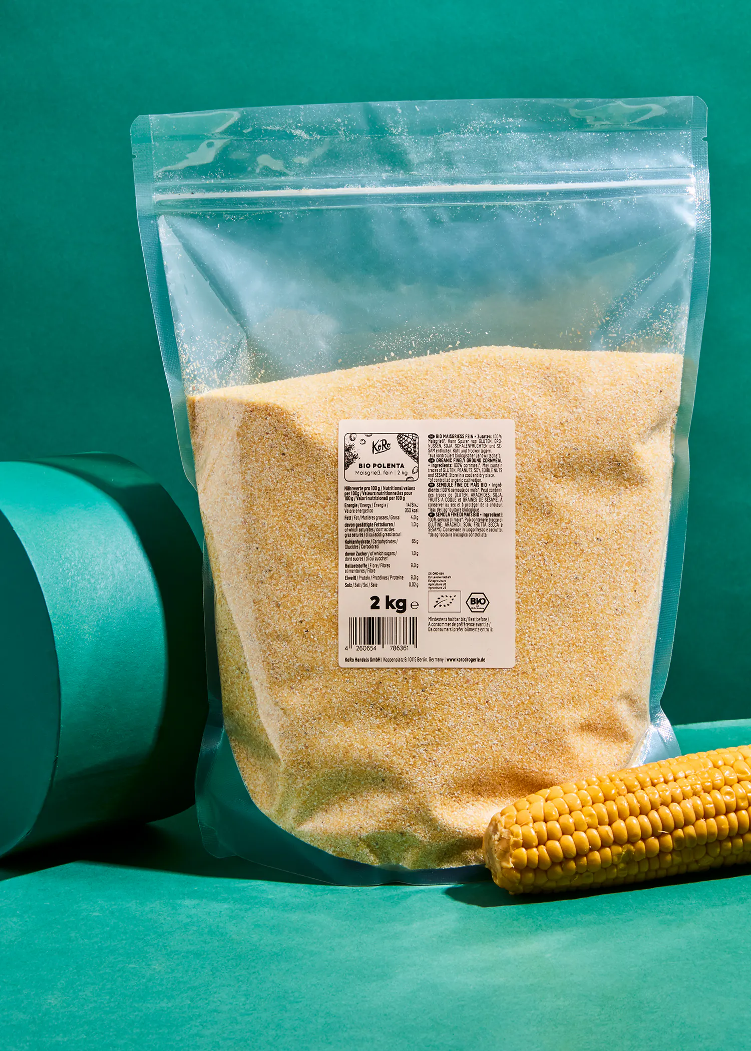 a bag of corn flour sits next to a corn cob
