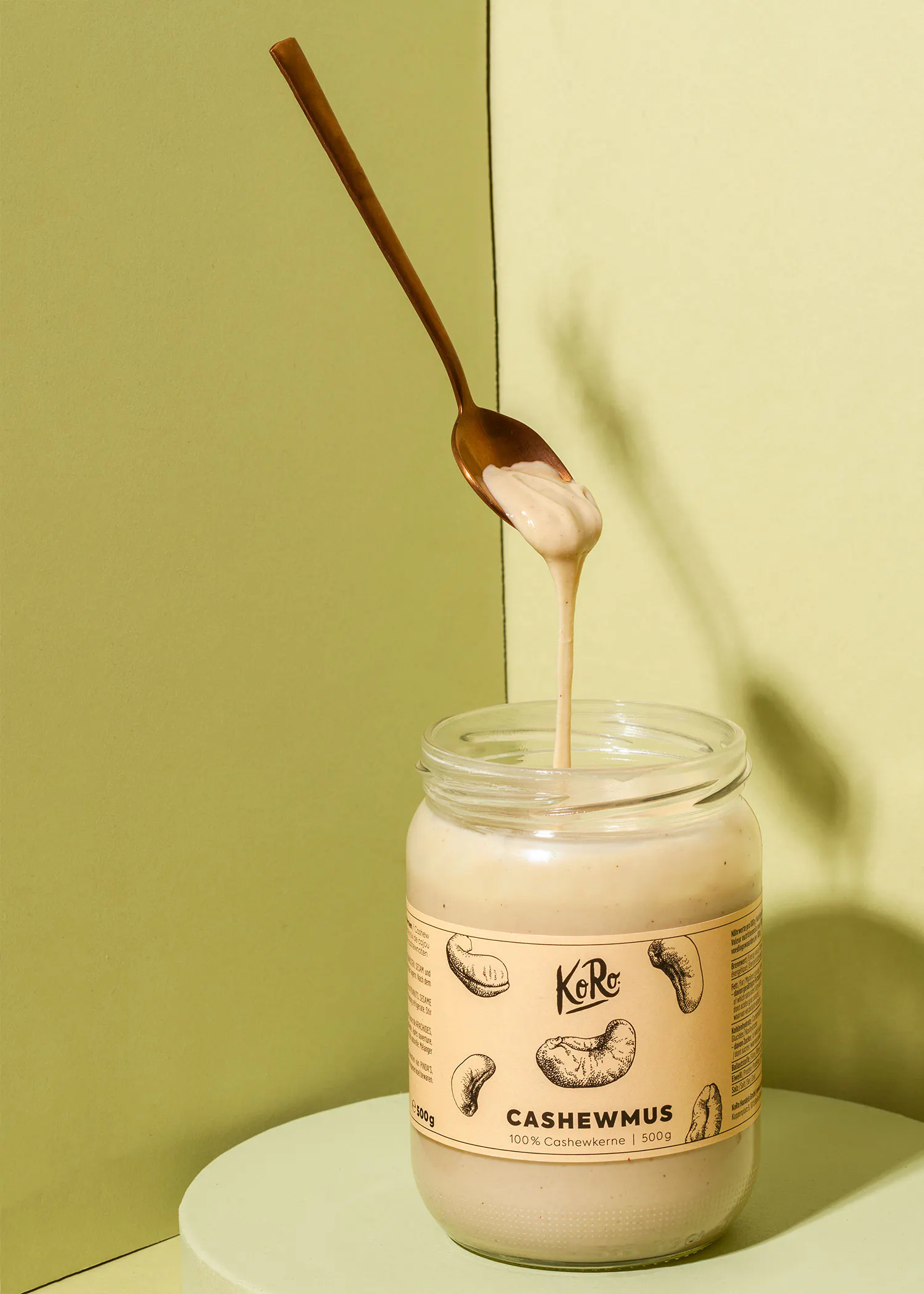 a jar of cashewmus with a spoon sticking out of it