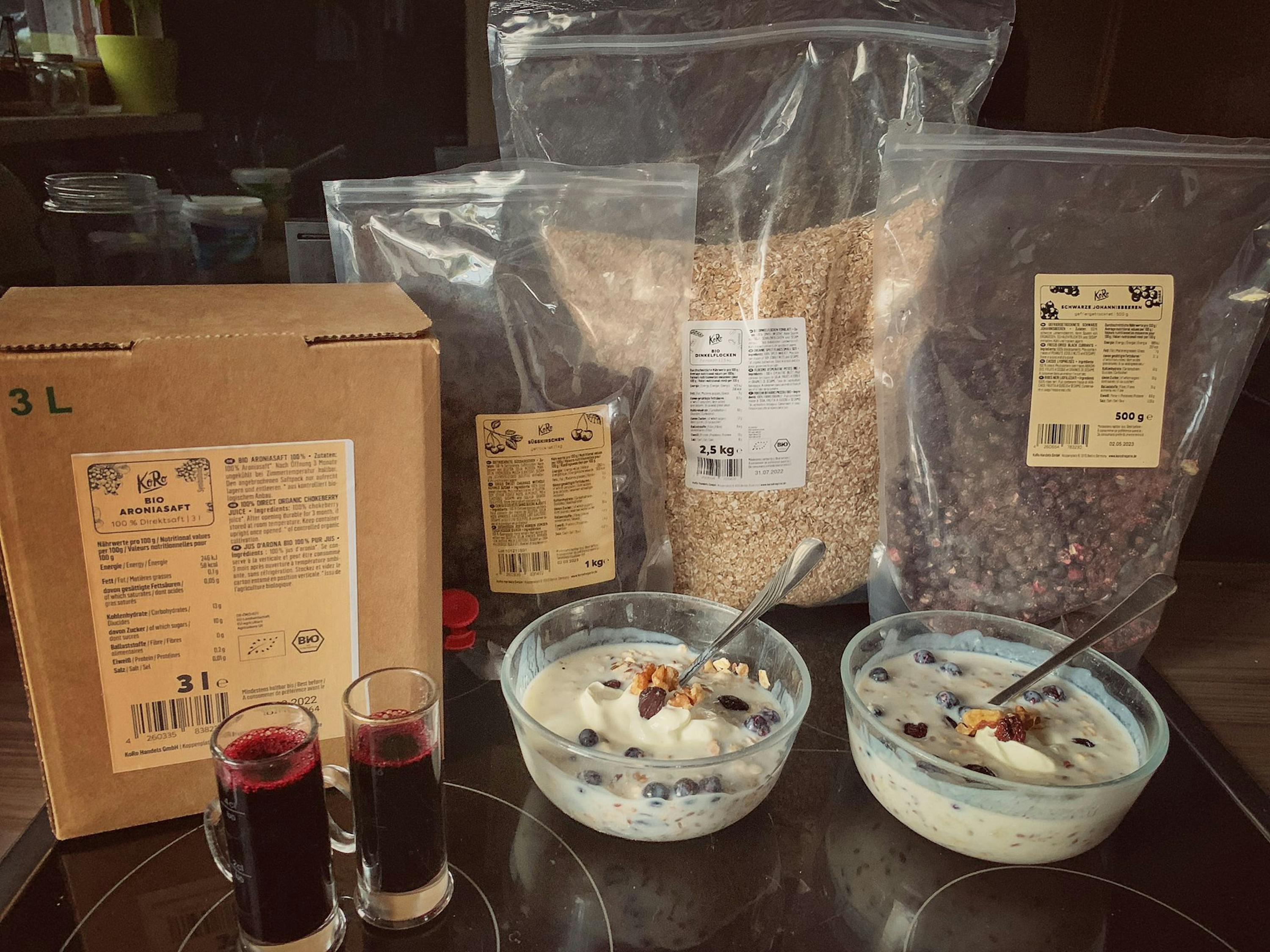 two bowls of yogurt next to a bag of oatmeal