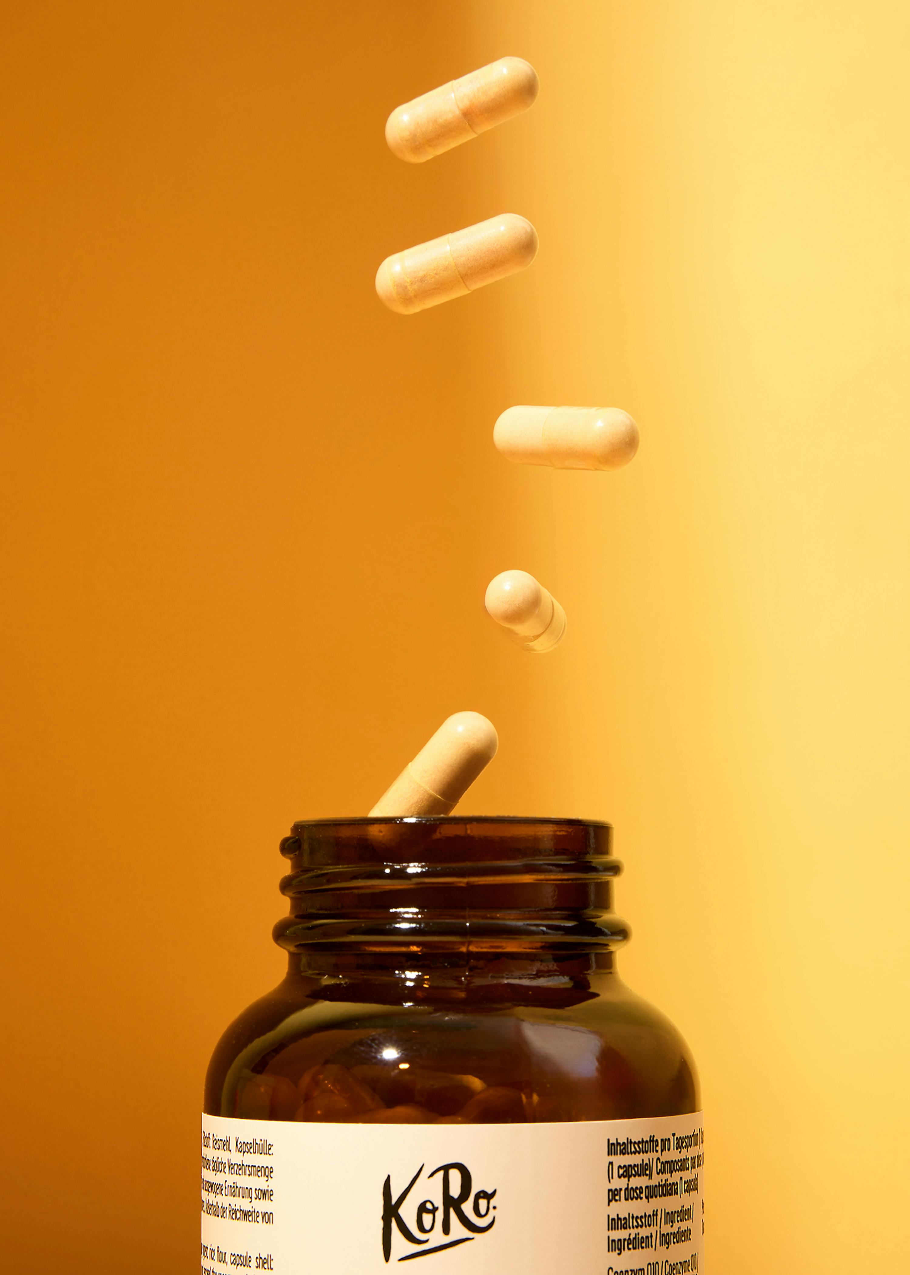 capsules falling out of a bottle that says koro