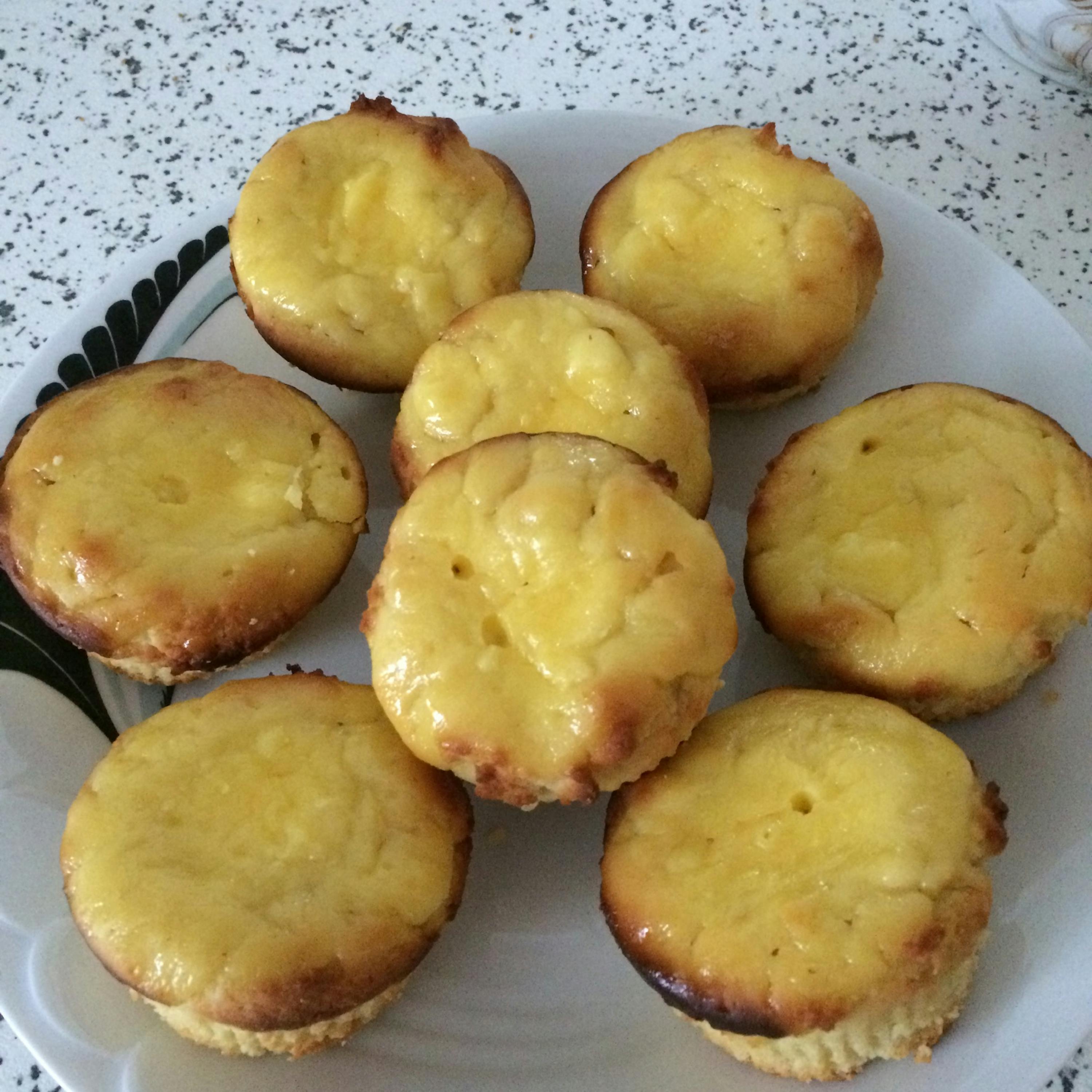 a white plate topped with a bunch of yellow cupcakes