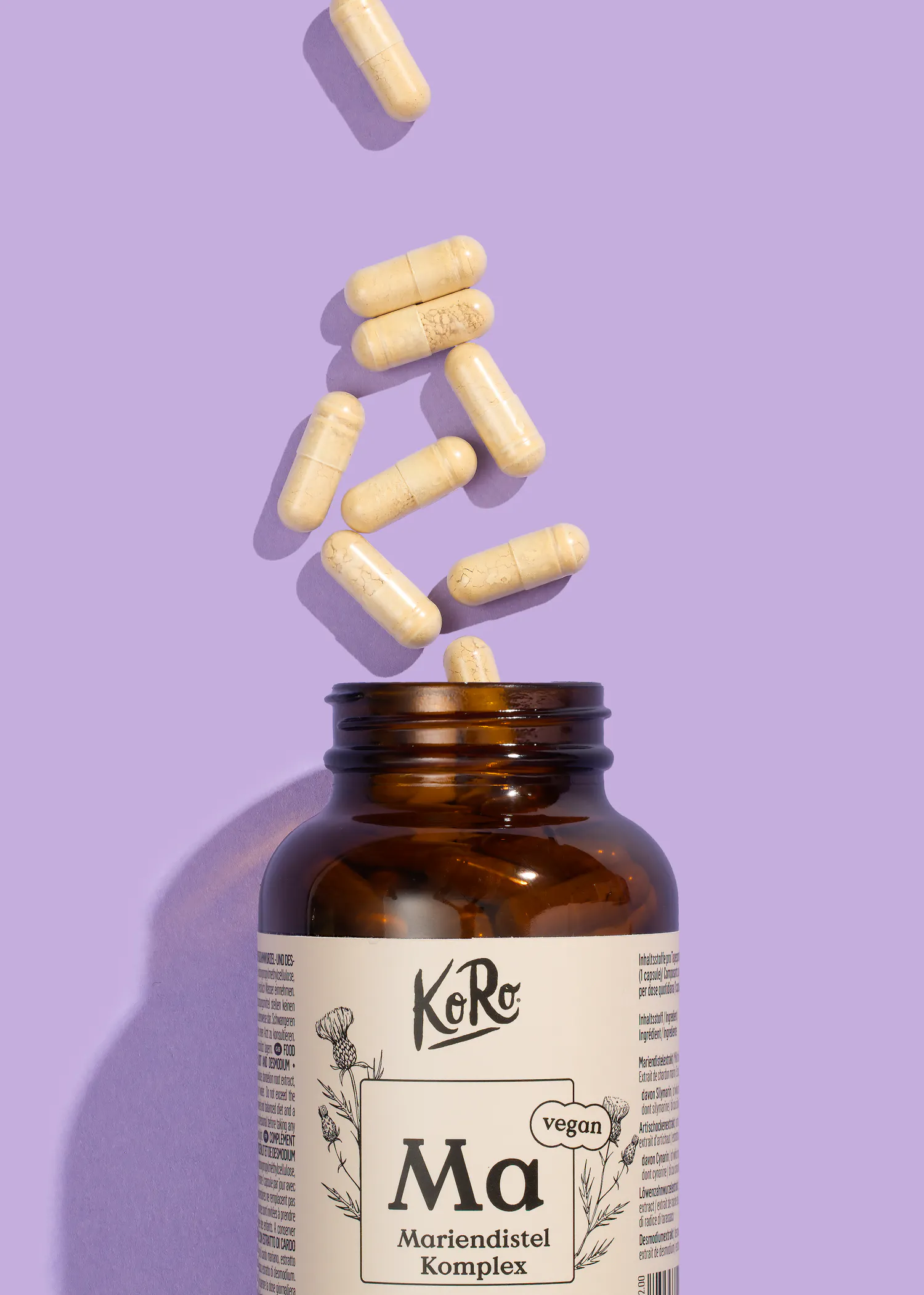 une bouteille de ma morindistel komplex avec des pilules tombant dessus