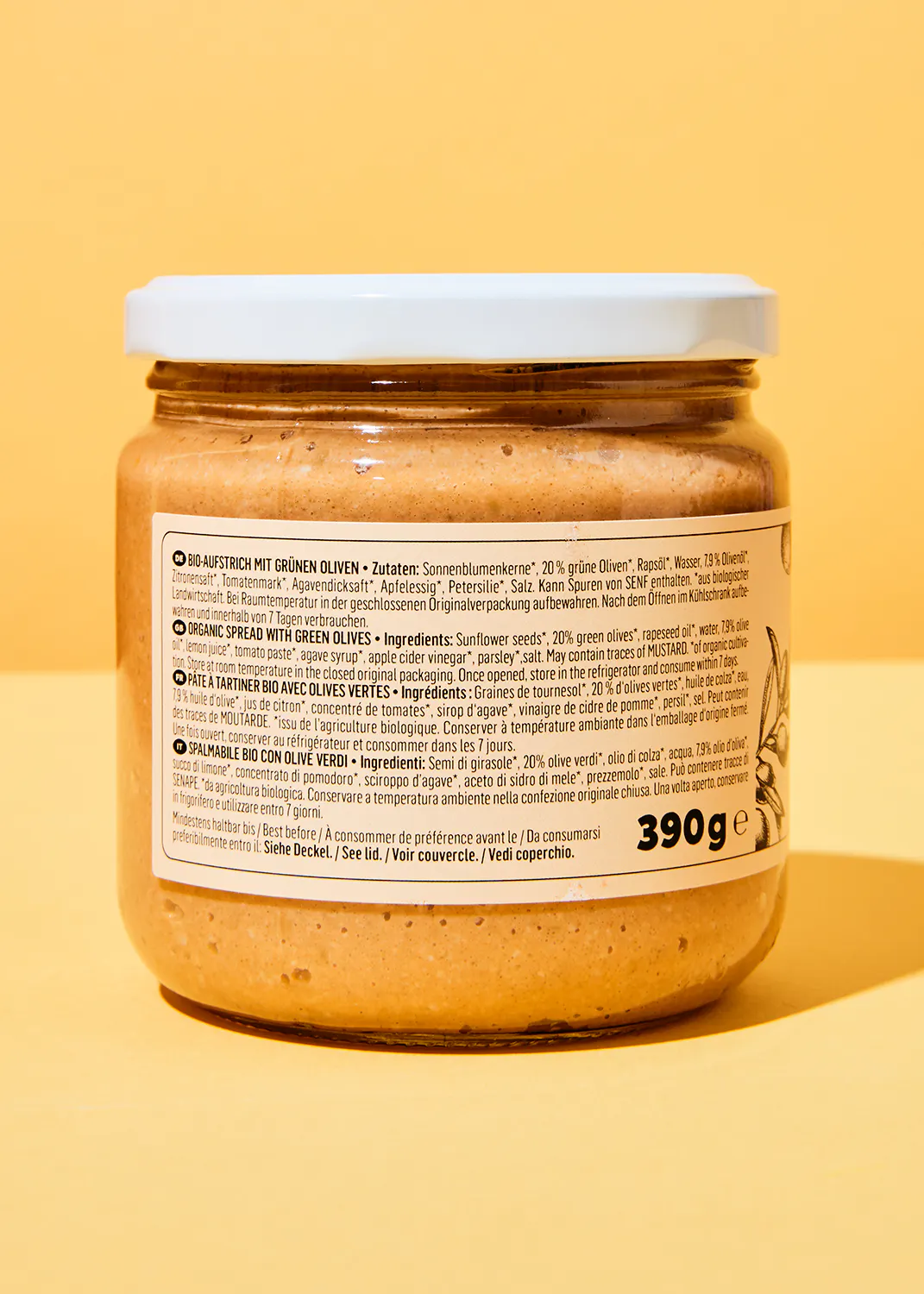 l' arrière d' un bocal de sauce avec des olives vertes