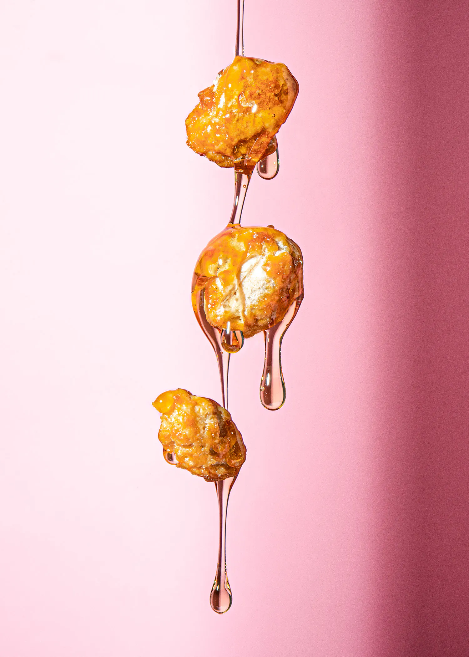 drei Stücke Popcorn werden mit Honig überzogen