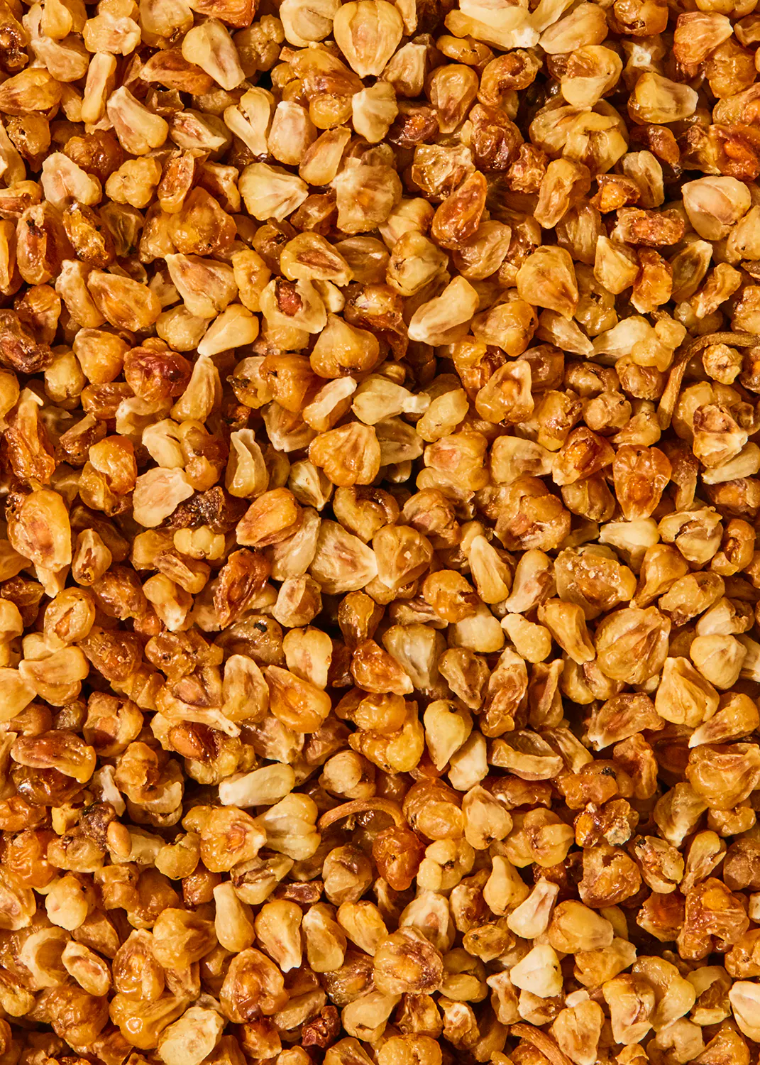 a close up of a pile of roasted corn