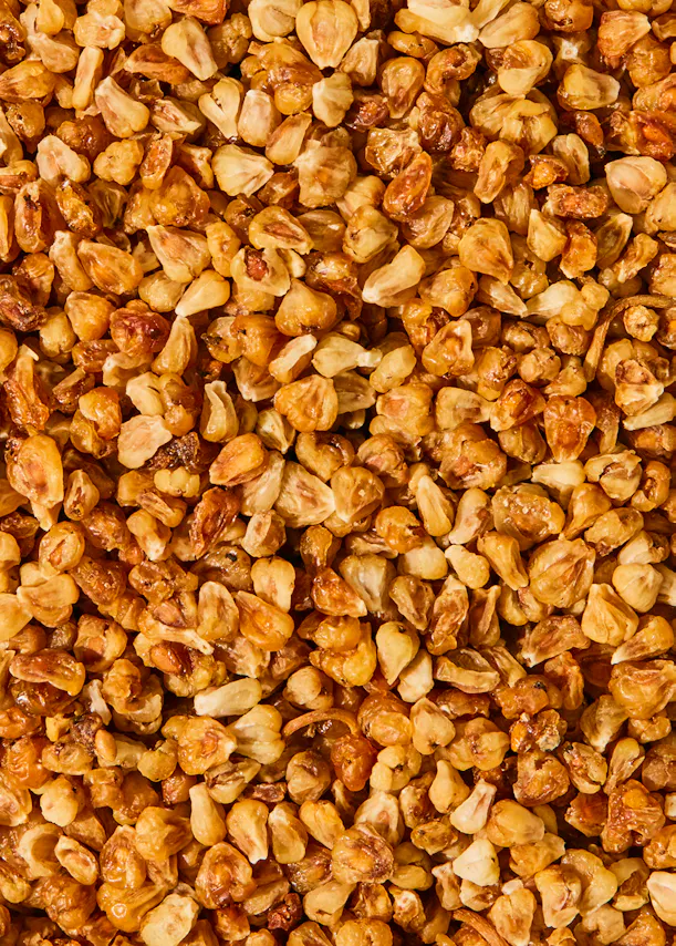 a close up of a pile of roasted corn