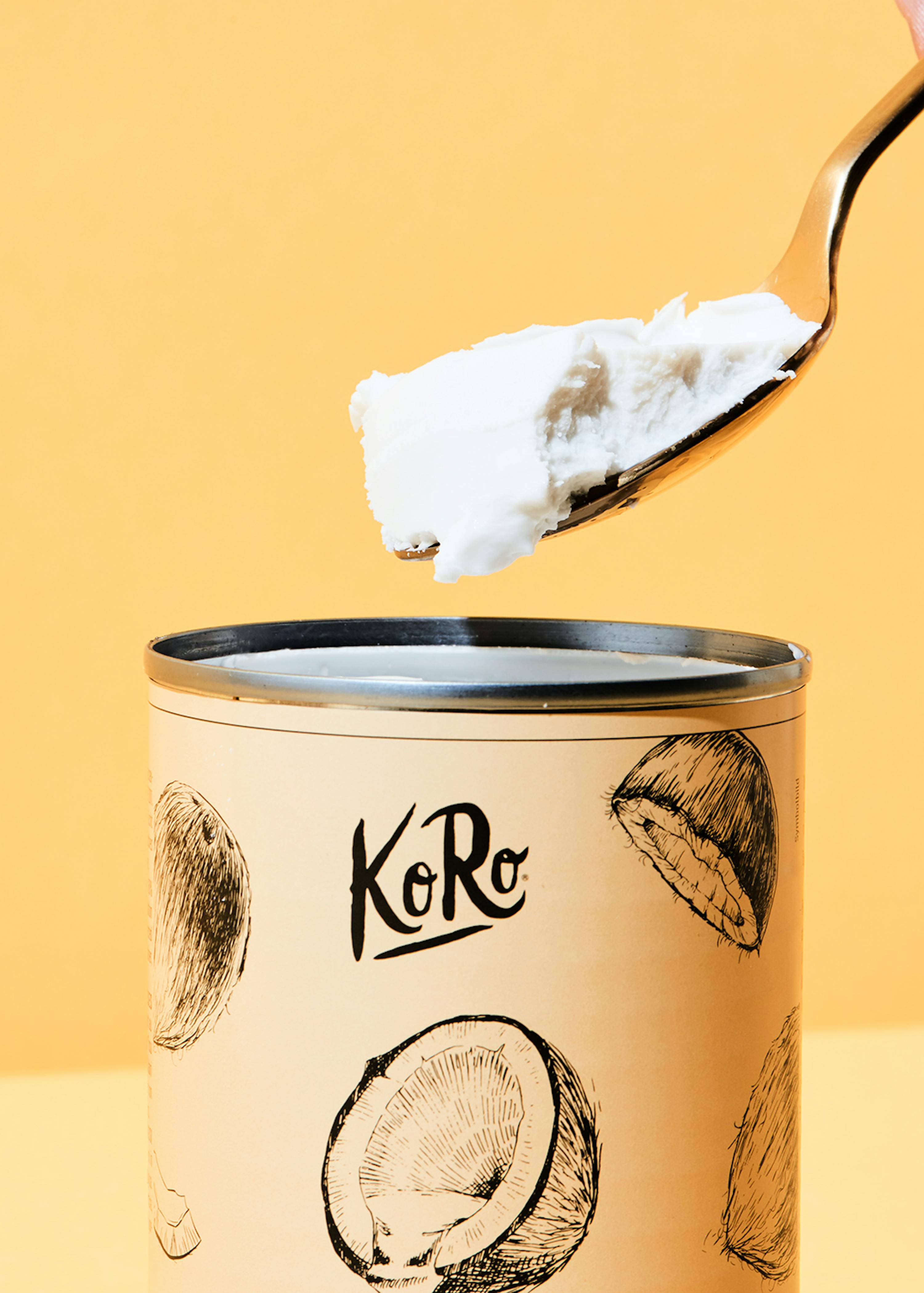 a spoon is being scooped out of a can that says koro