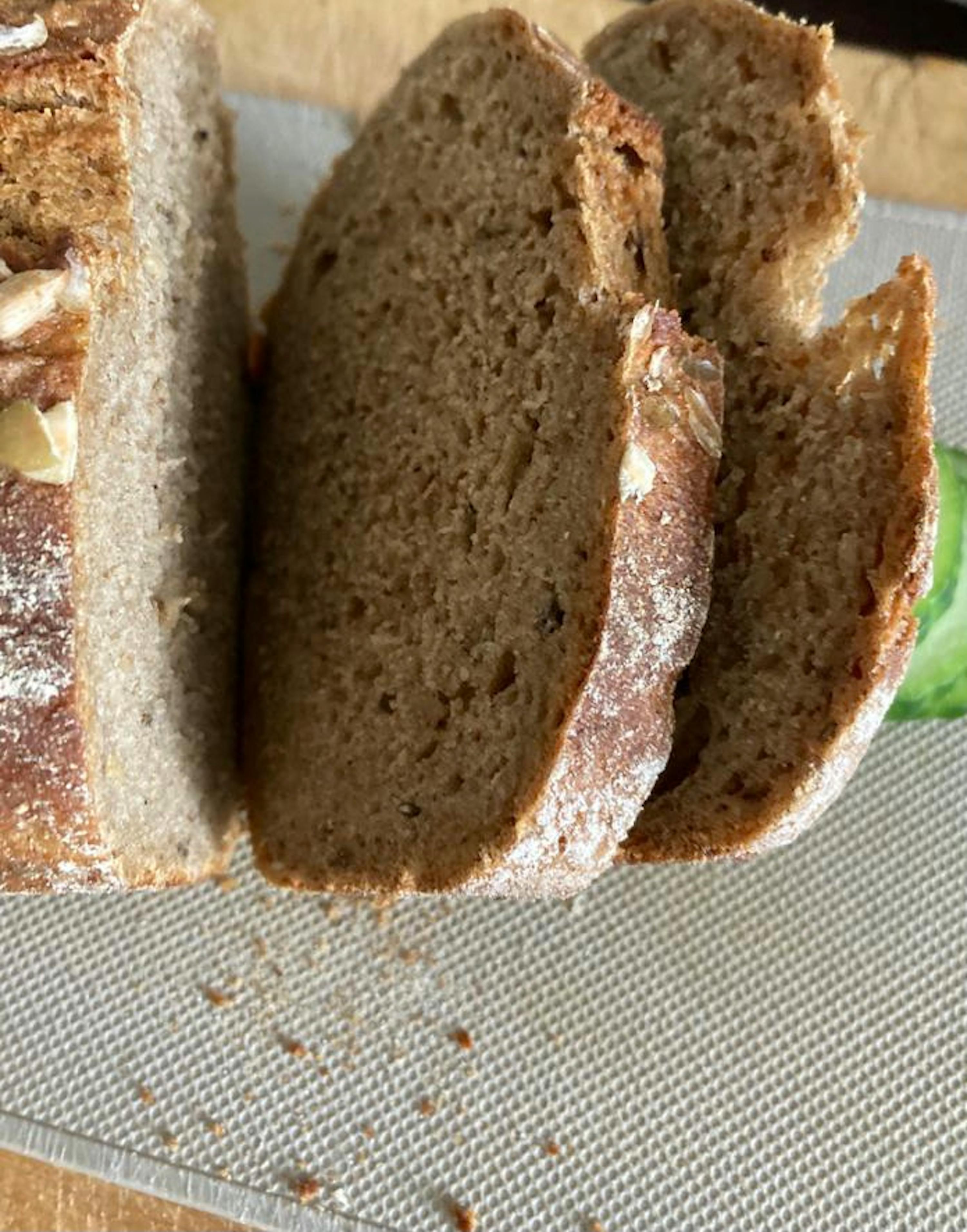 a loaf of bread that has been sliced on a cutting board