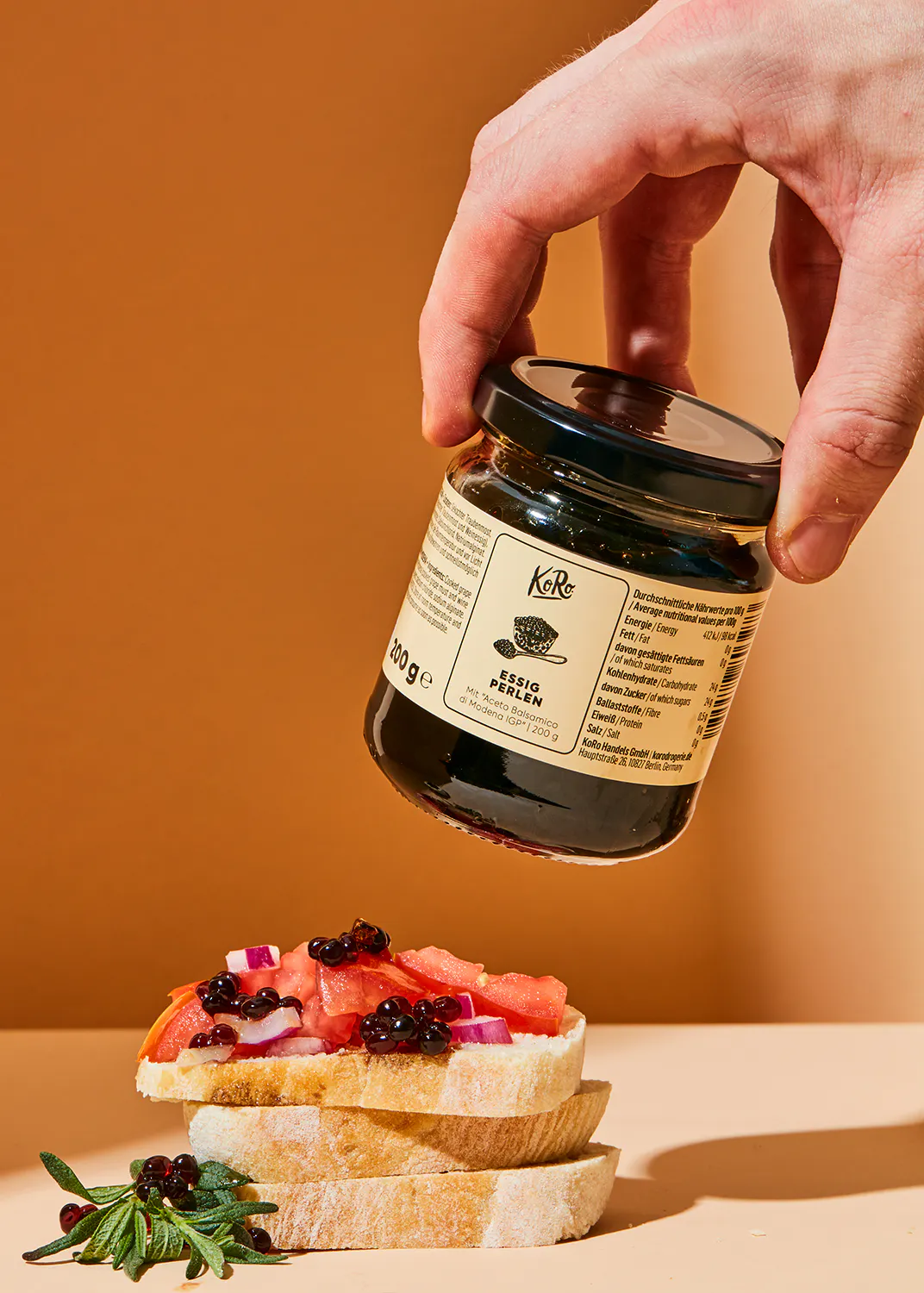 a person is holding a jar of espio green on top of a sandwich