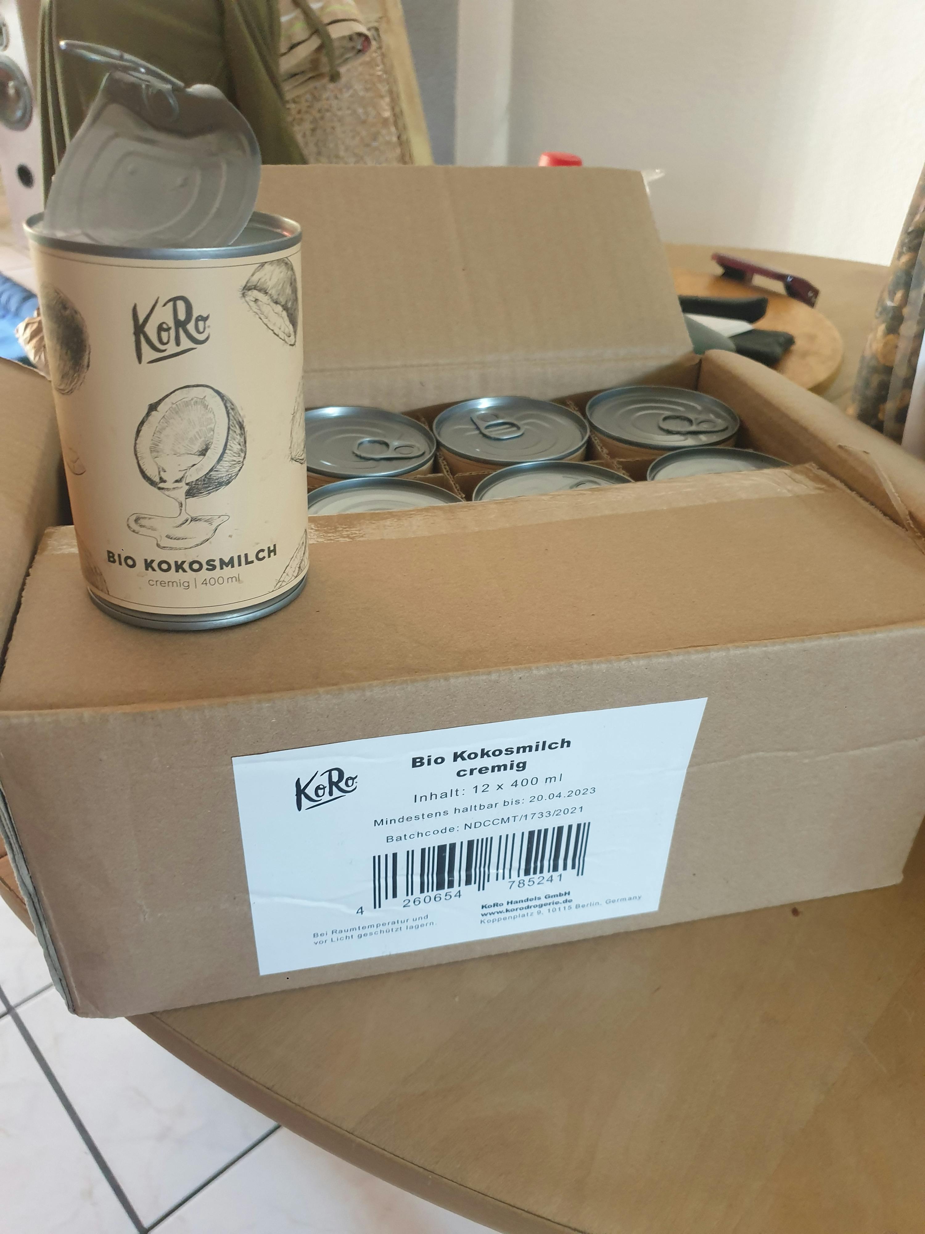 a can of bio kokosmilch sits in front of a cardboard box